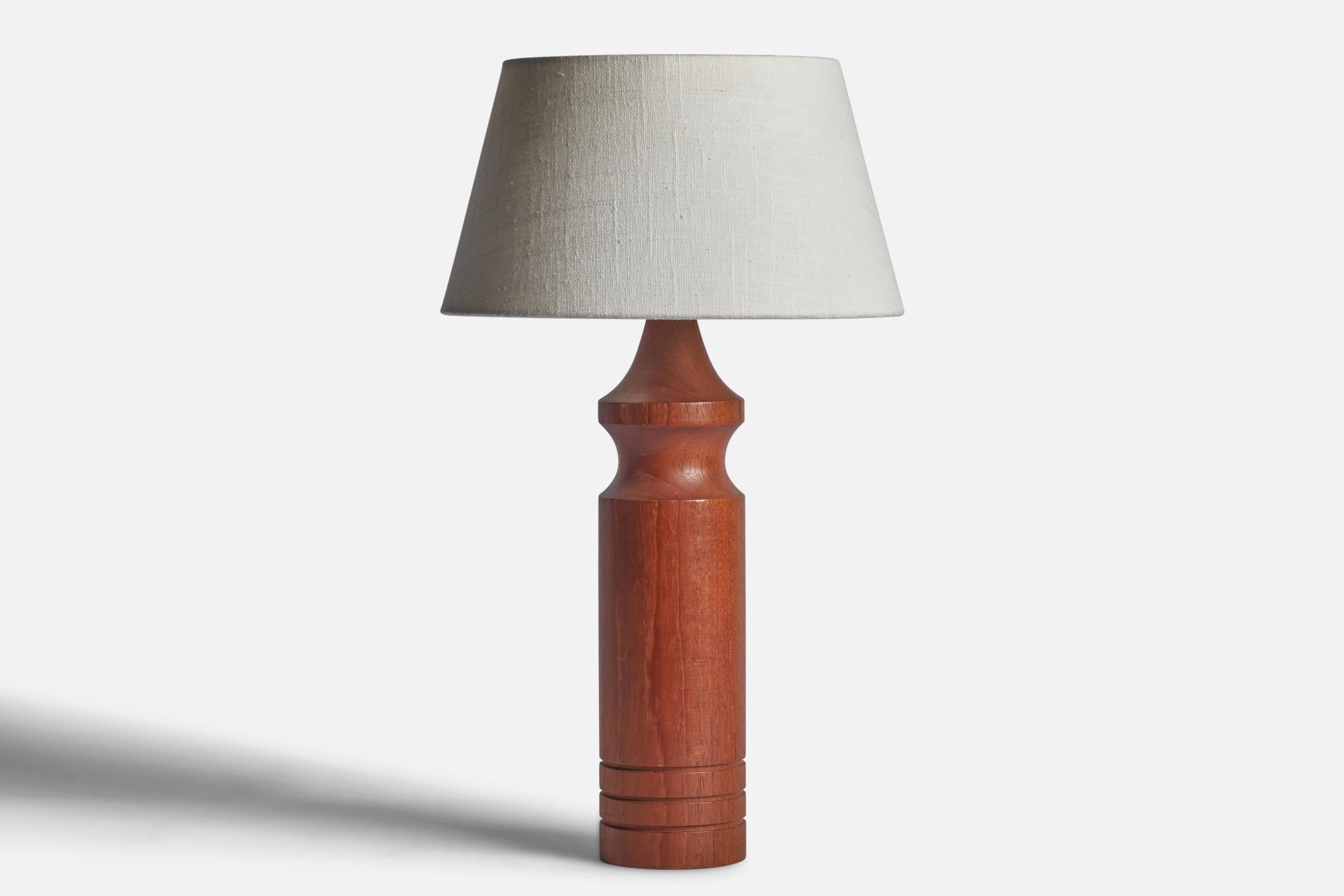 A teak table lamp designed and produced in Sweden, 1950s.

Dimensions of Lamp (inches): 10.75” H x 5.75” Diameter
Dimensions of Shade (inches): 7” Top Diameter x 10” Bottom Diameter x 5.5” H 
Dimensions of Lamp with Shade (inches): 17.25” H x 10”