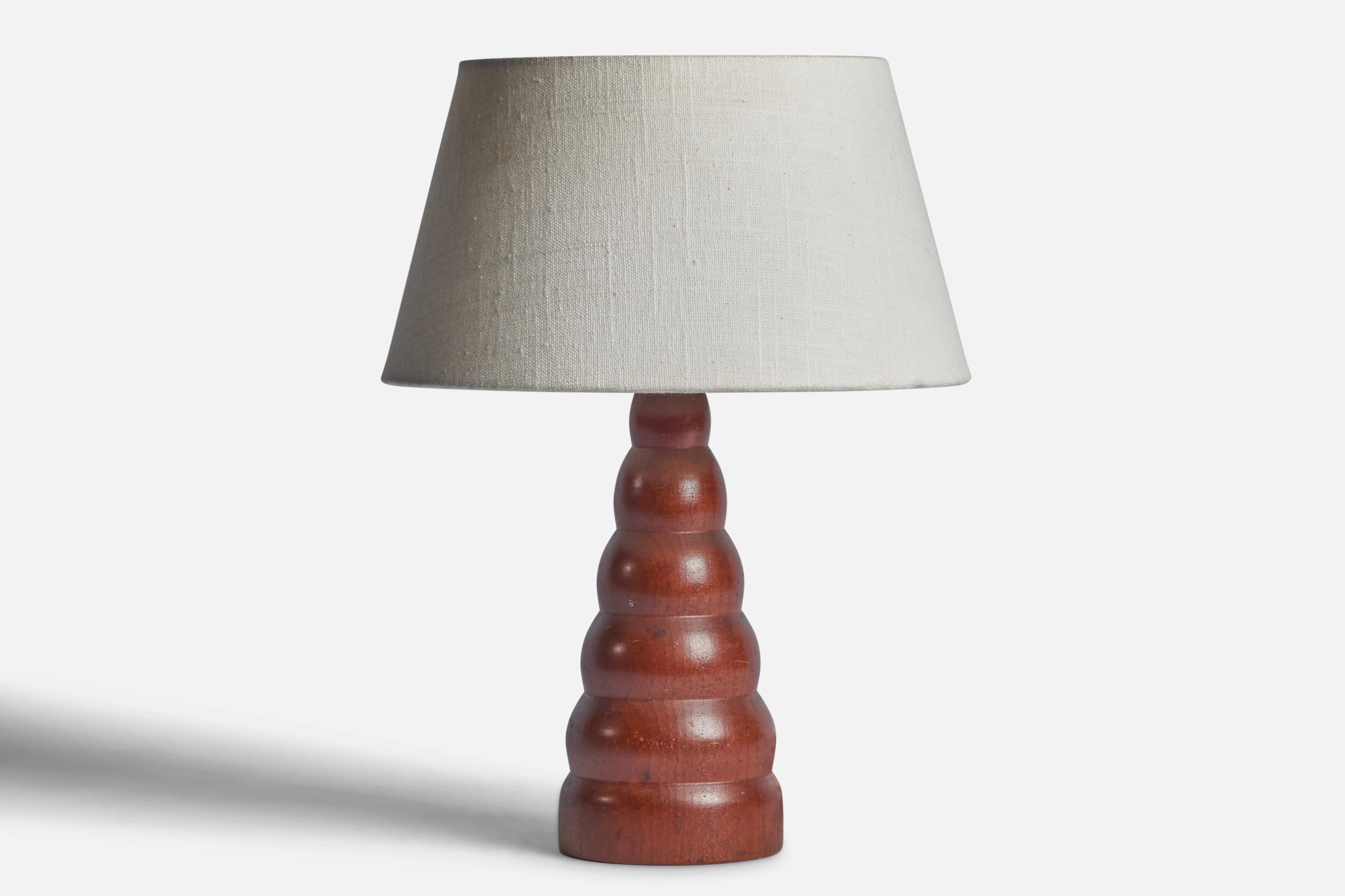A teak table lamp designed and produced in Sweden, c. 1950s.

Dimensions of Lamp (inches): 10.75” H x 5.75” Diameter
Dimensions of Shade (inches): 7” Top Diameter x 10” Bottom Diameter x 5.5” H 
Dimensions of Lamp with Shade (inches): 13.65” H x 10”