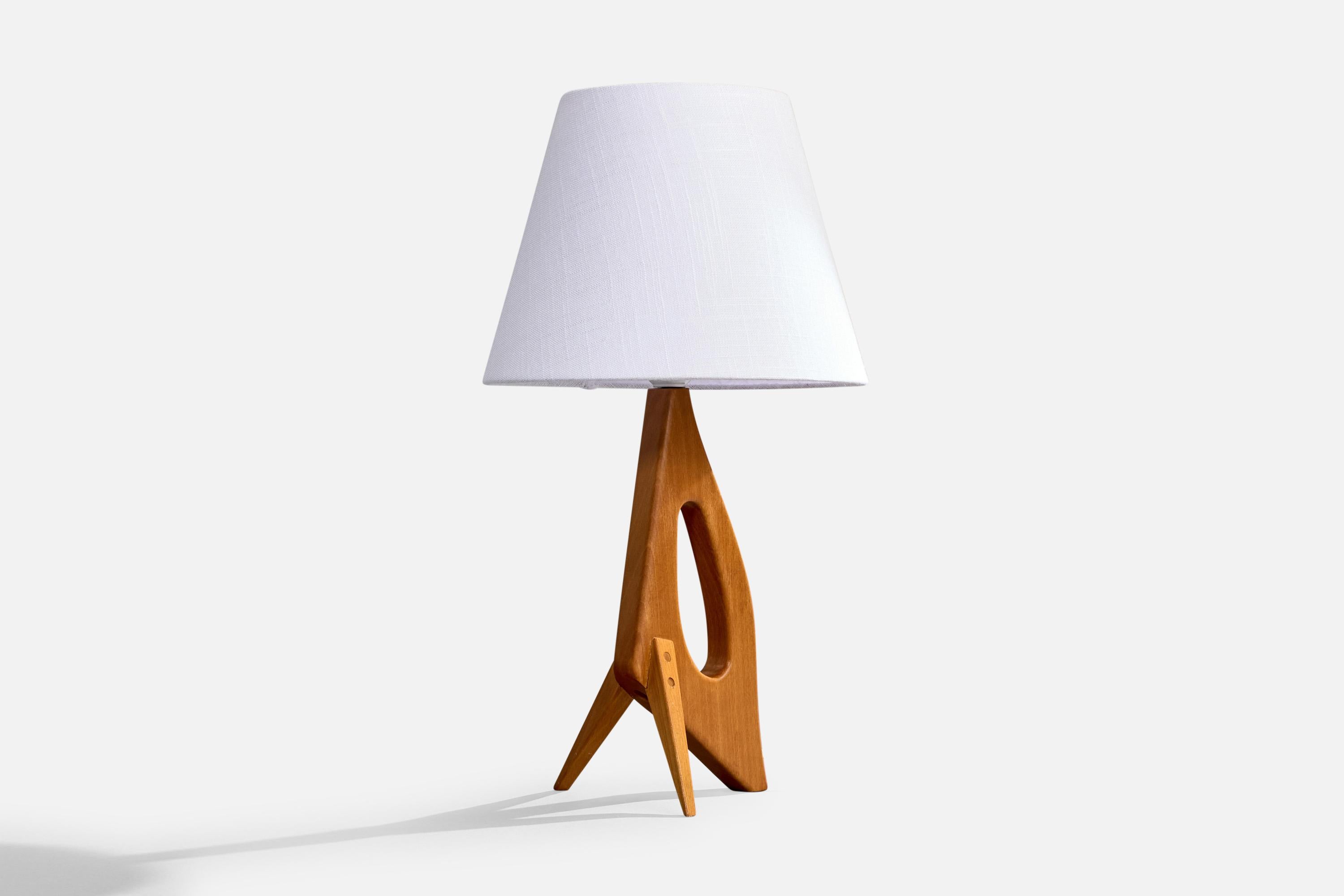 A teak table lamp designed and produced in Sweden, c. 1950s.

Dimensions of Lamp (inches): 13” H x 5.125” W x 5.5” D

Dimensions of Shade (inches): 6” Top Diameter x 10” Bottom Diameter x 8” H

Dimensions of Lamp with Shade (inches): 18.25” H x 10”