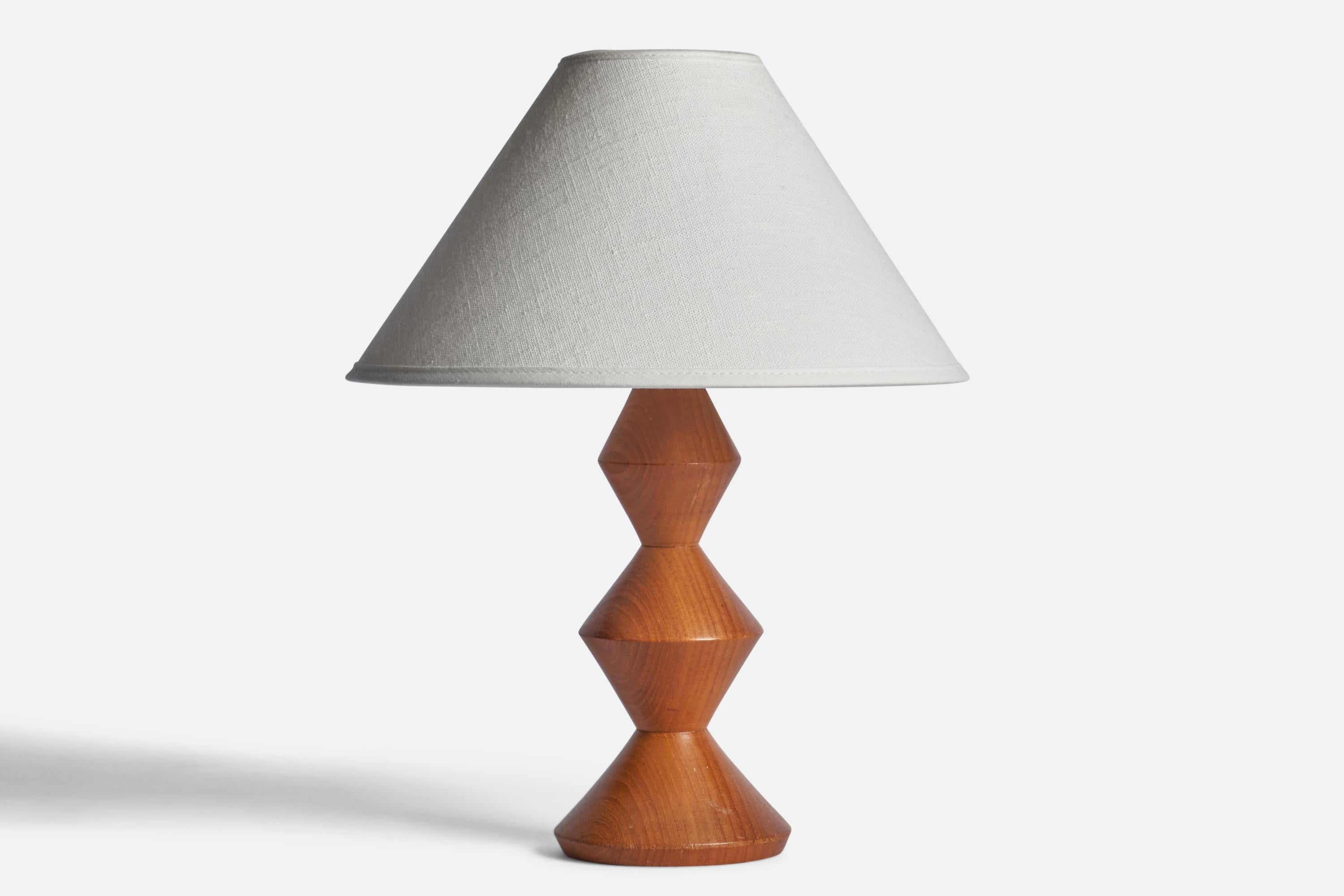 A teak table lamp designed and produced in Sweden, 1960s.

Dimensions of Lamp (inches): 10” H x 4” Diameter
Dimensions of Shade (inches): 2.5” Top Diameter x 10” Bottom Diameter x 5.5