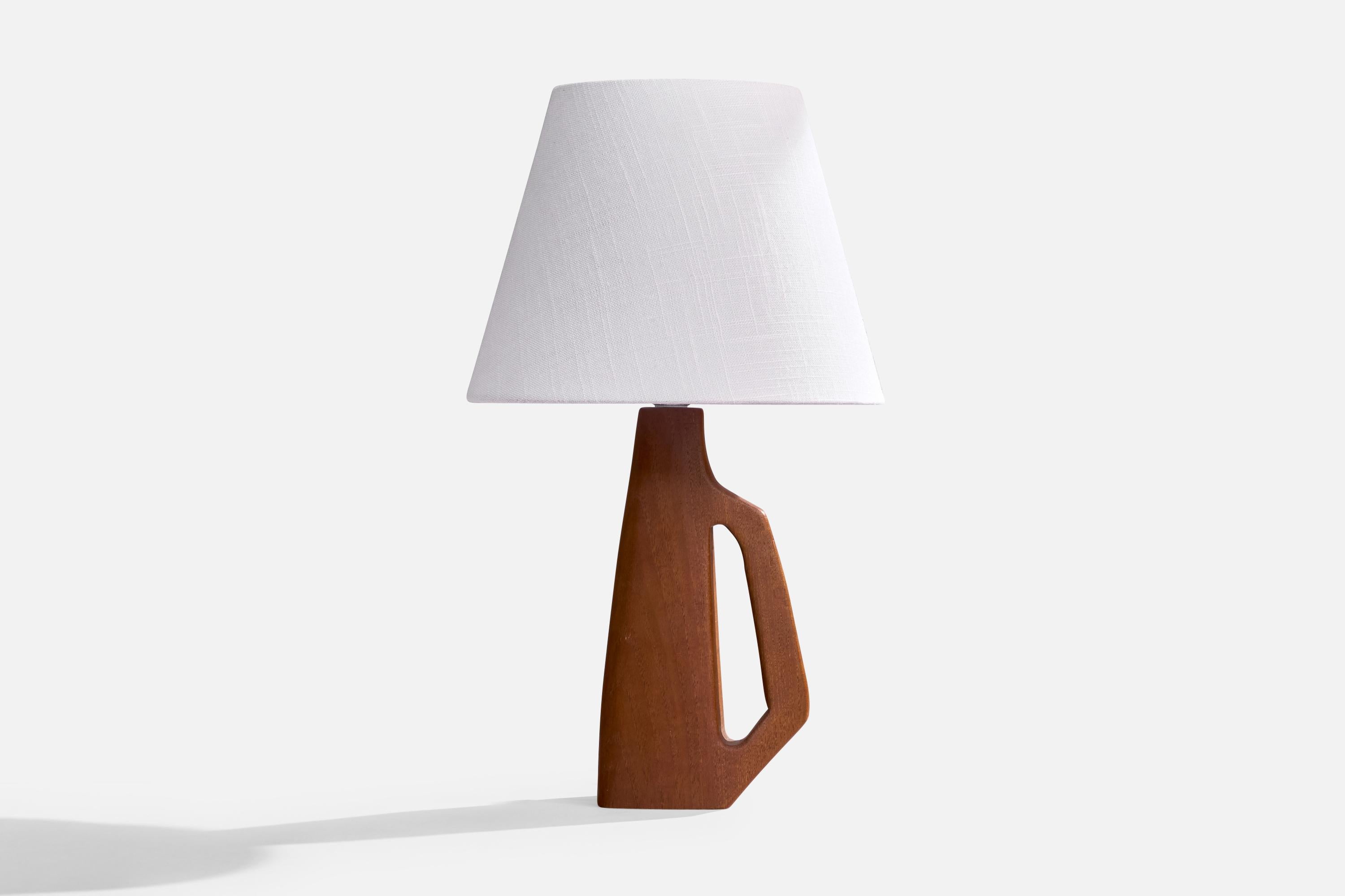 A teak table lamp designed and produced in Sweden, c. 1960s.

Dimensions of Lamp (inches): 11.75” H x 5“ W x 2.625” D

Dimensions of Shade (inches): 6” Top Diameter x 10“ Bottom Diameter x 8“ H

Dimensions of Lamp with Shade (inches): 17.25“ H x 8”