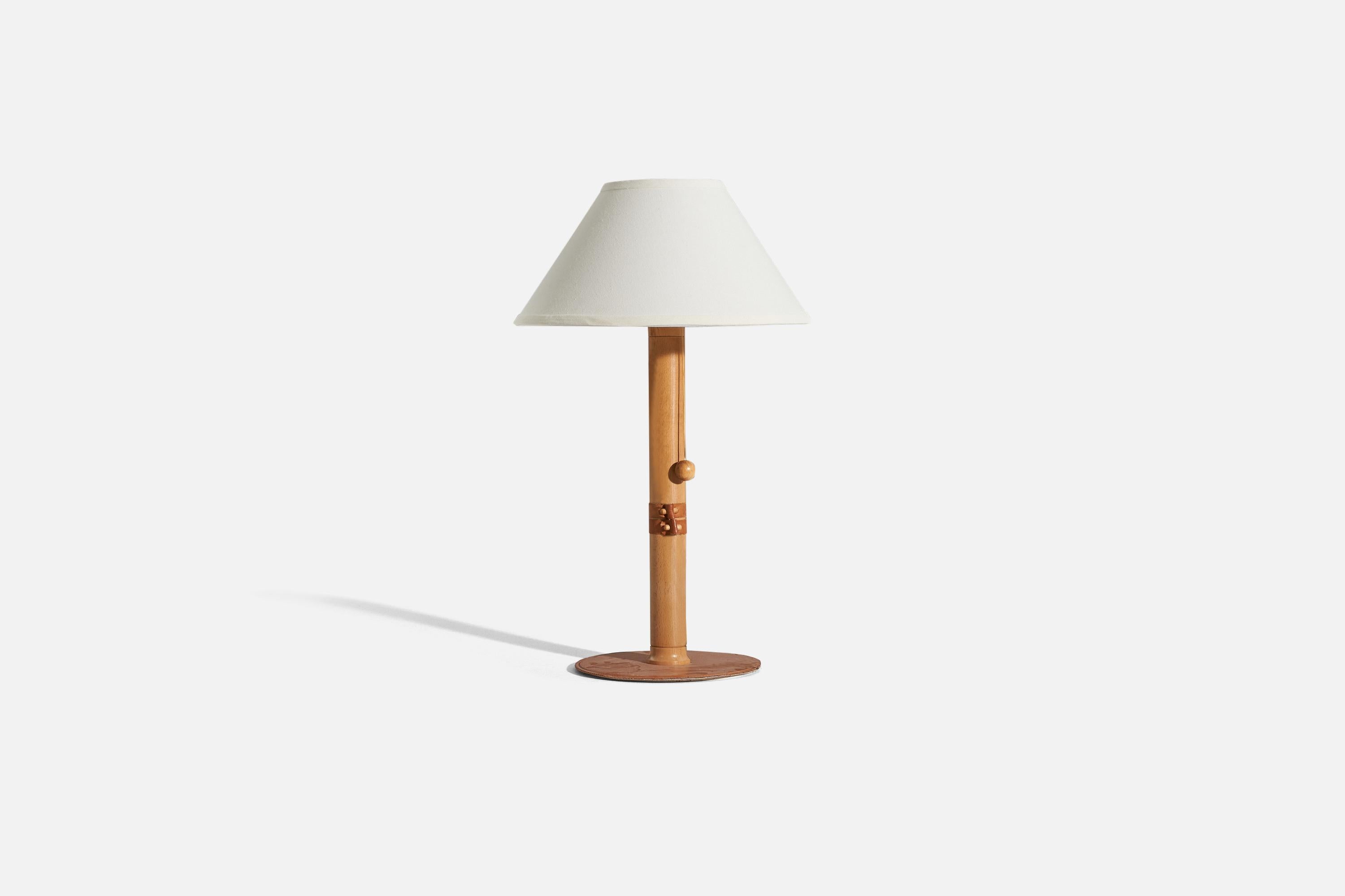A wood and leather table lamp designed and produced by a Swedish designer, Sweden, 1970s.

Sold without lampshade. 
Dimensions of lamp (inches) : 19.5625 x 9.125 x 9.125 (H x W x D)
Dimensions of shade (inches) : 5.75 x 14 x 8 (T x B x