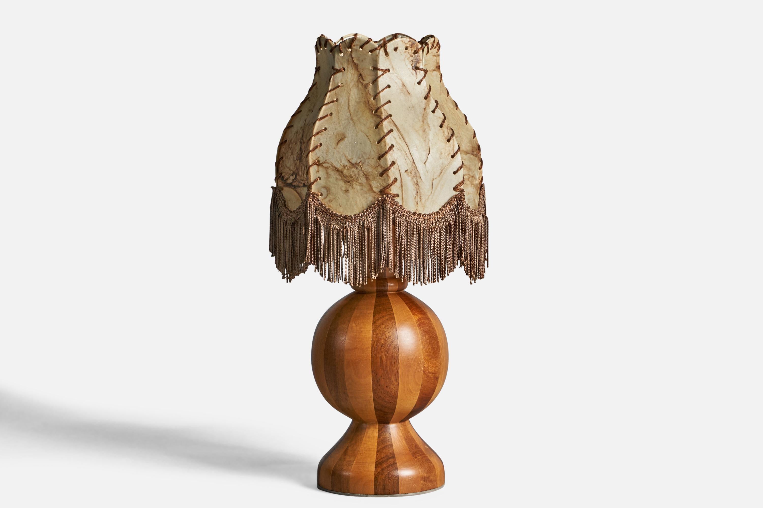 A stack-laminated wood, fabric string and beige parchment paper table lamp, designed and produced in Sweden, c. 1970s.

Overall Dimensions (inches): 18
