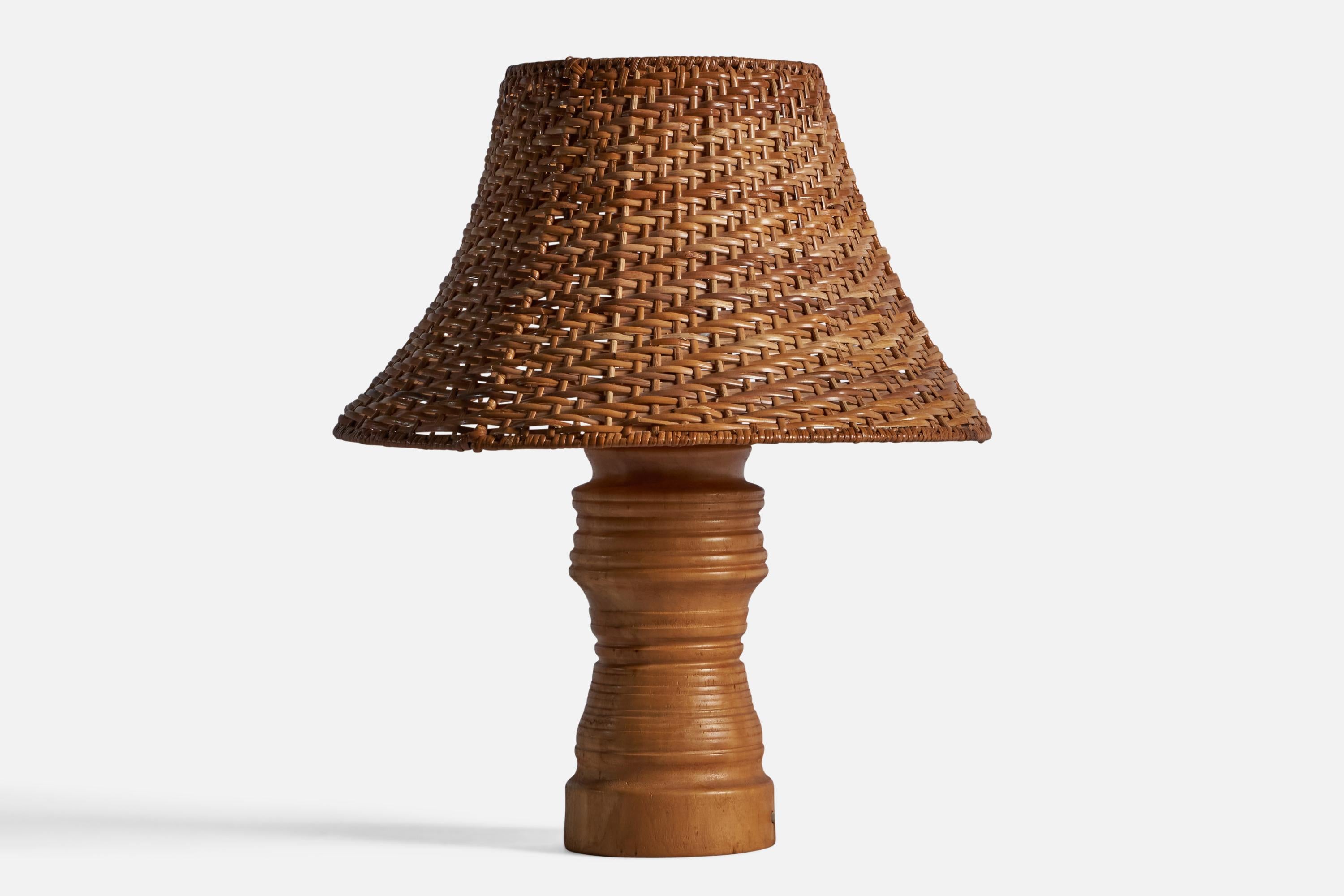 A solid turned wood and rattan table lamp designed and produced in Sweden, 1960s.

Overall Dimensions: 17.25