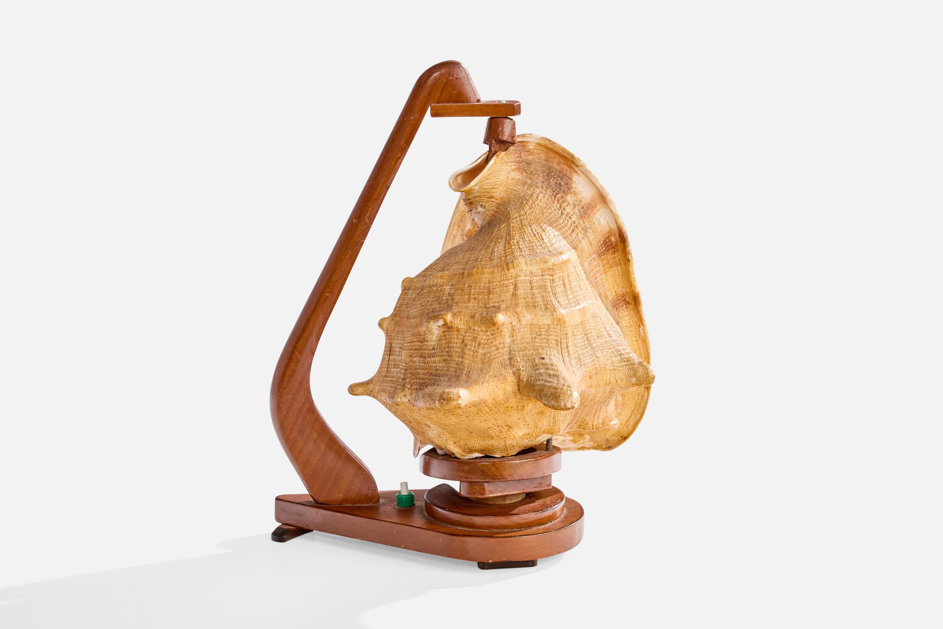 A table lamp in stained wood with a shell used as a diffuser, likely designed and produced in Sweden, c. 1940s.

Dimensions of Lamp (inches): 13.0