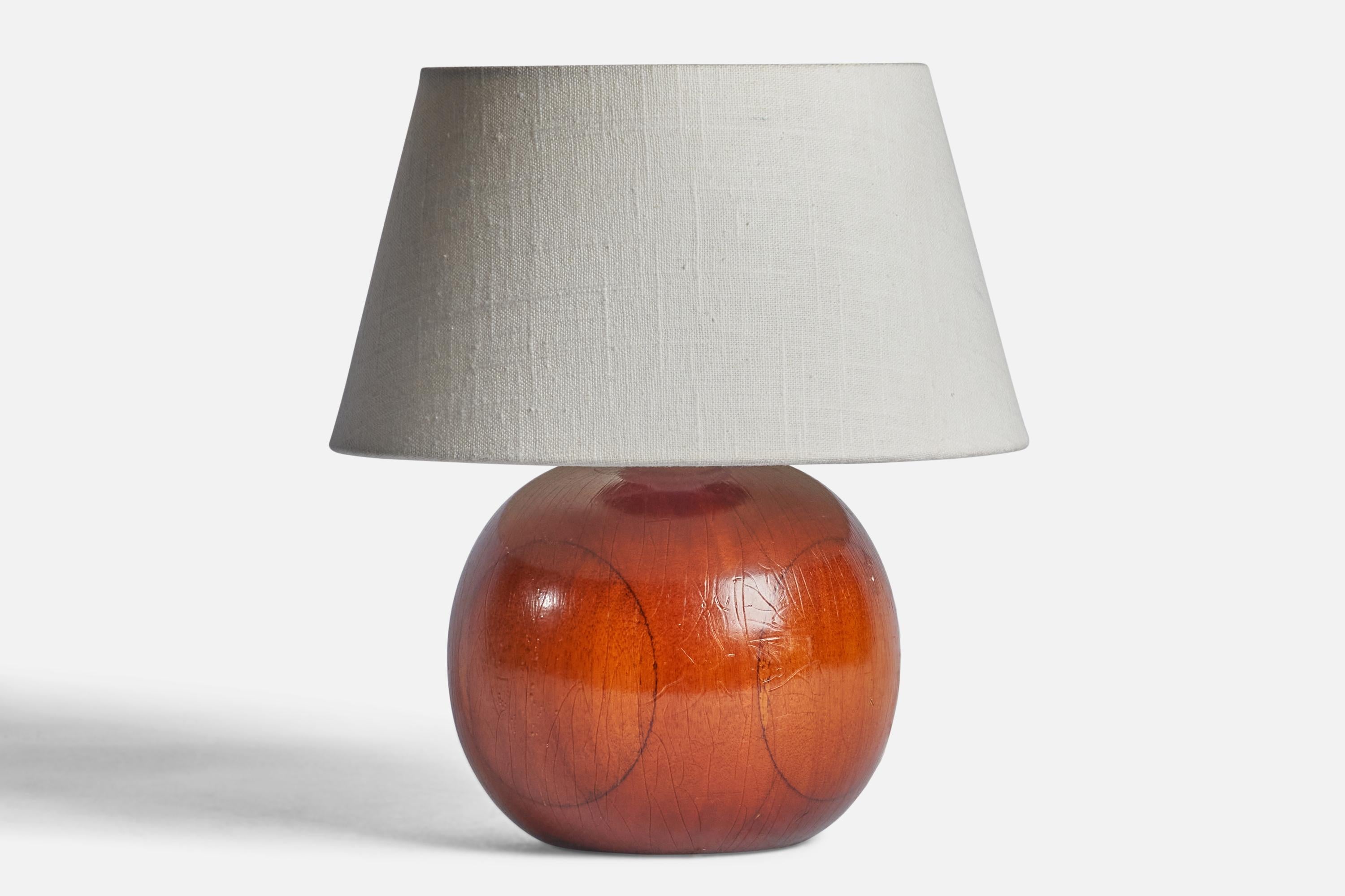 A wood table lamp designed and produced in Sweden, 1950s

Dimensions of Lamp (inches): 7.65 H x 6” Diameter
Dimensions of Shade (inches): 7” Top Diameter x 10” Bottom Diameter x 5.5” H 
Dimensions of Lamp with Shade (inches): 11” H x 10”