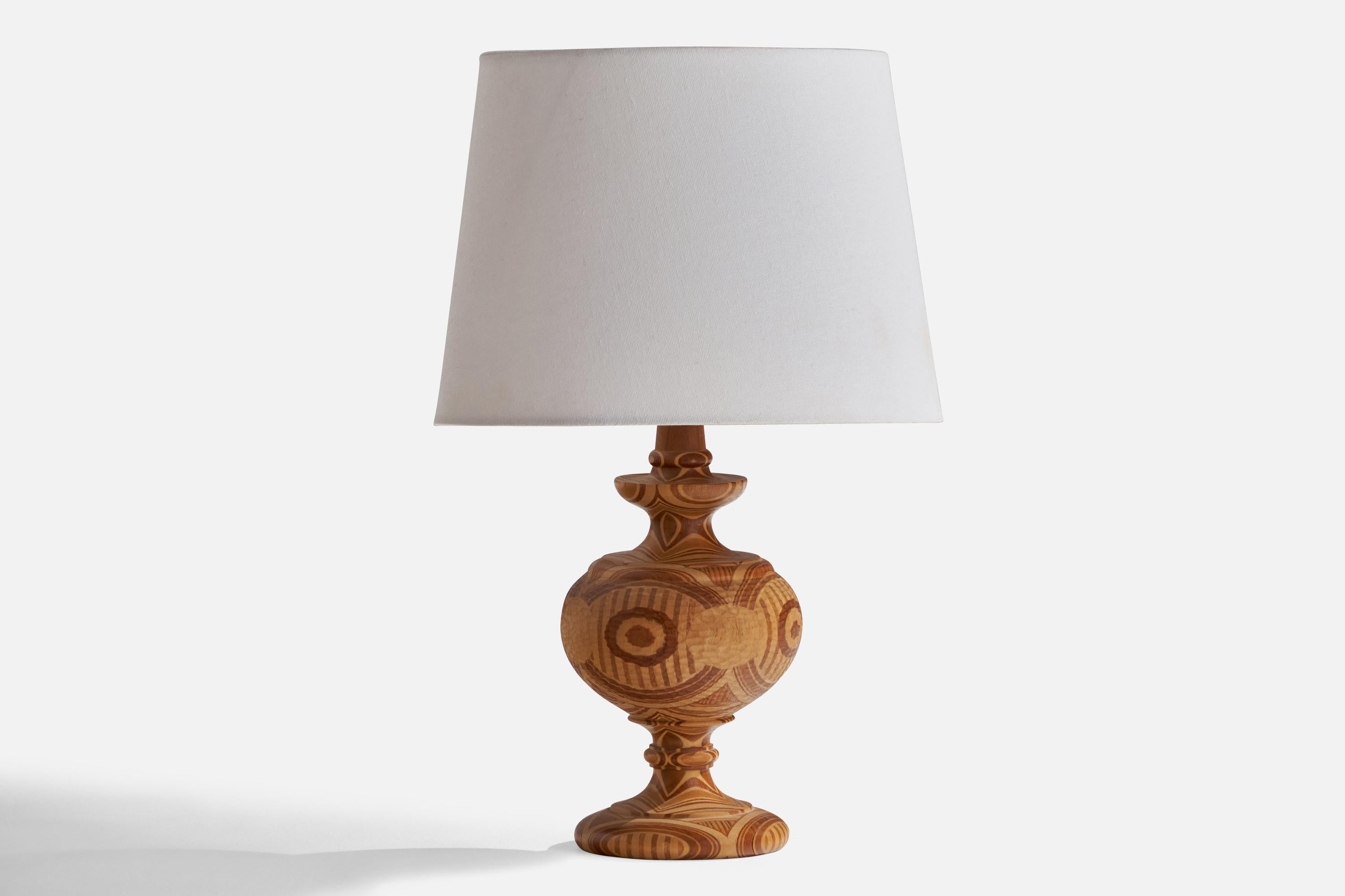 A stack-laminated mixed woods table lamp designed and produced in Sweden, 1967.

Dimensions of Lamp (inches): 10.5” H x 4.75” Diameter
Dimensions of Shade (inches): 8” Top Diameter x 9.75” Bottom Diameter x 7.25” H
Dimensions of Lamp with Shade