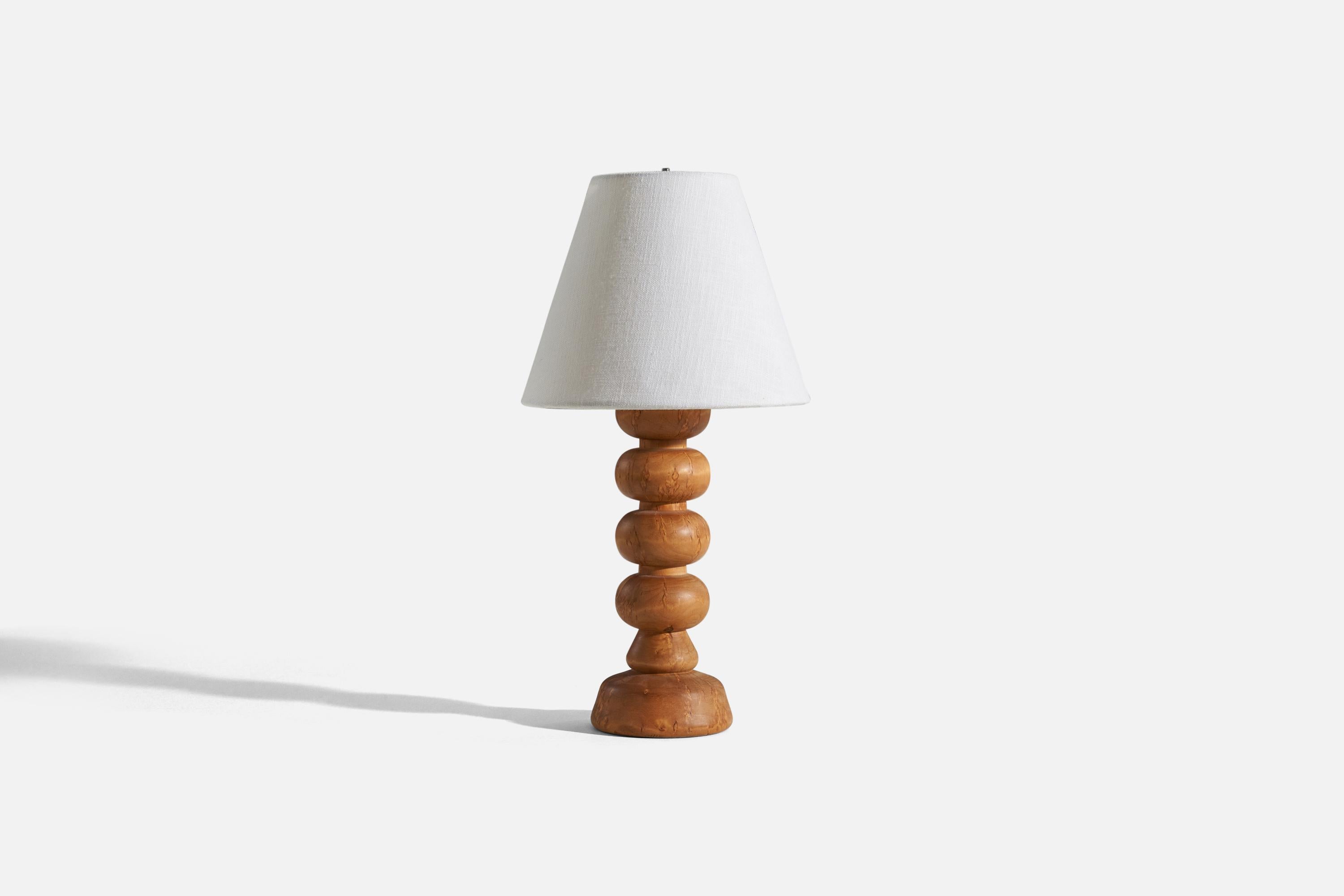 A wooden table lamp, designed and produced by a Swedish designer, Sweden, 1970s.

Sold without lampshade. 
Dimensions of Lamp (inches) : 12 x 4 x 4 (H x W x D)
Dimensions of Shade (inches) : 4 x 8 x 6.75 (T x B x H)
Dimension of Lamp with Shade