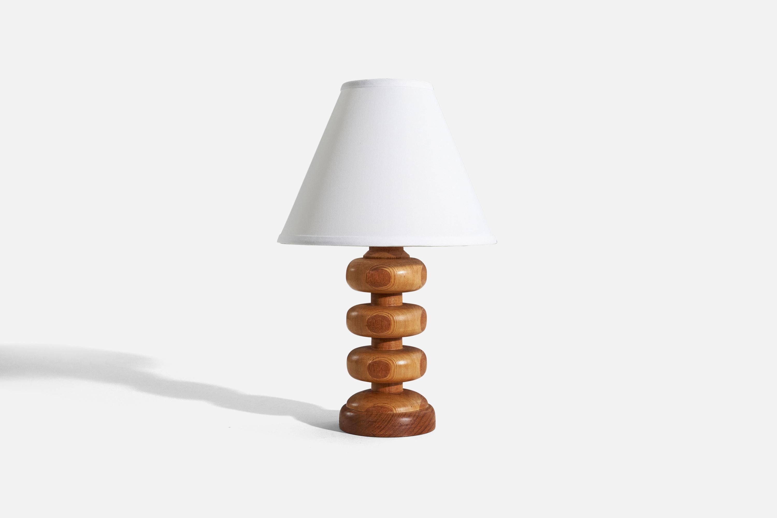 A wooden table lamp, designed and produced by a Swedish designer, Sweden, 1970s.

Sold without lampshade. 
Dimensions of Lamp (inches) : 12.375 x 4.625 x 4.625 (H x W x D)
Dimensions of Shade (inches) : 4.25 x 10.25 x 8 (T x B x H)
Dimension of