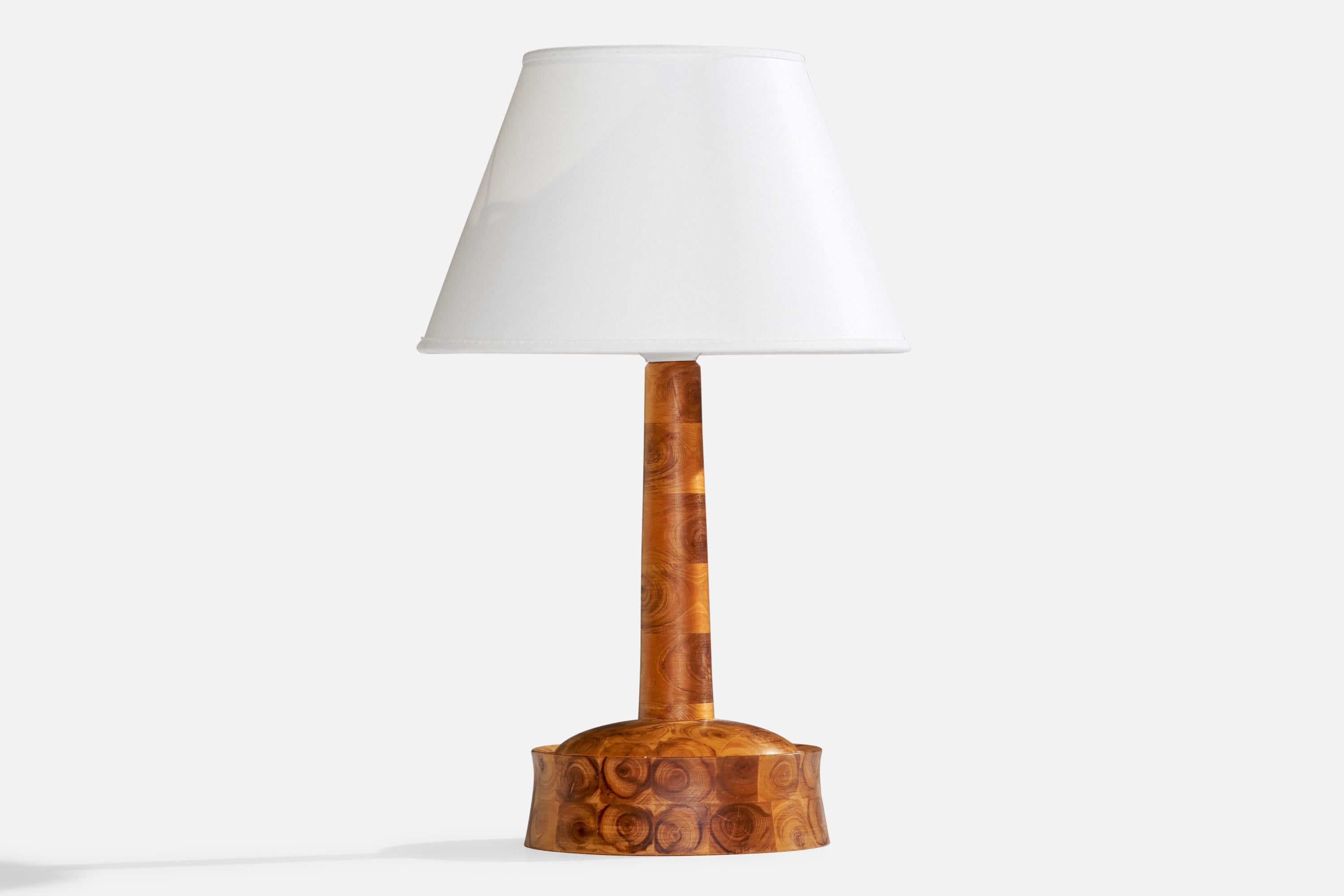 A stack-laminated wood table lamp designed and produced in Sweden, c. 1970s.

Dimensions of Lamp (inches): 10.5” H x 5” Diameter
Dimensions of Shade (inches): 4.5” Top Diameter x 8”  Bottom Diameter x 5.25” H
Dimensions of Lamp with Shade (inches):