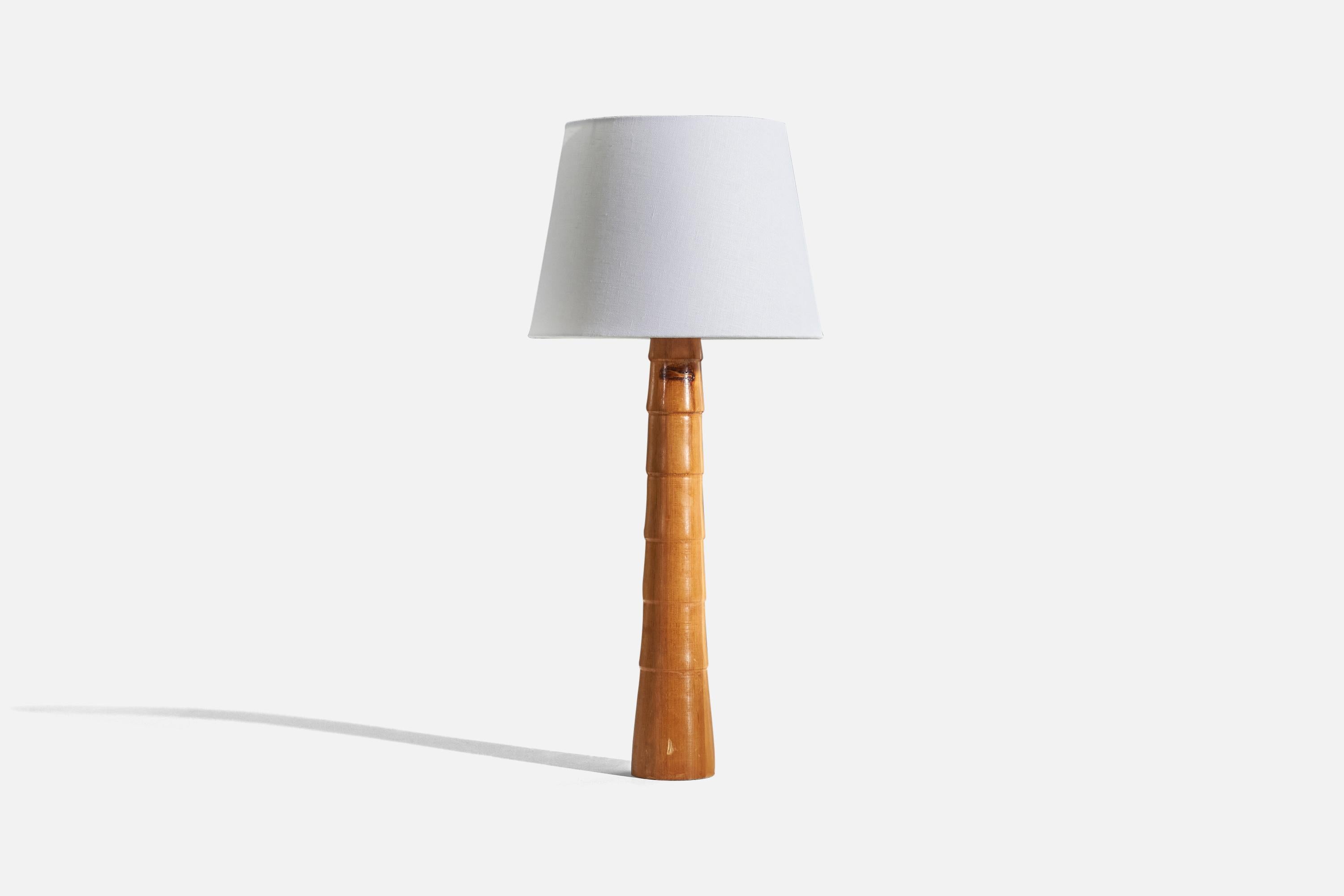A wooden table lamp designed and produced in Sweden, c. 1960s. 

Sold without lampshade. 
Dimensions of lamp (inches) : 21.43 x 3.56 x 3.56 (H x W x D)
Dimensions of shade (inches) : 9 x 12 x 9 (T x B x S)
Dimension of lamp with shade (inches)