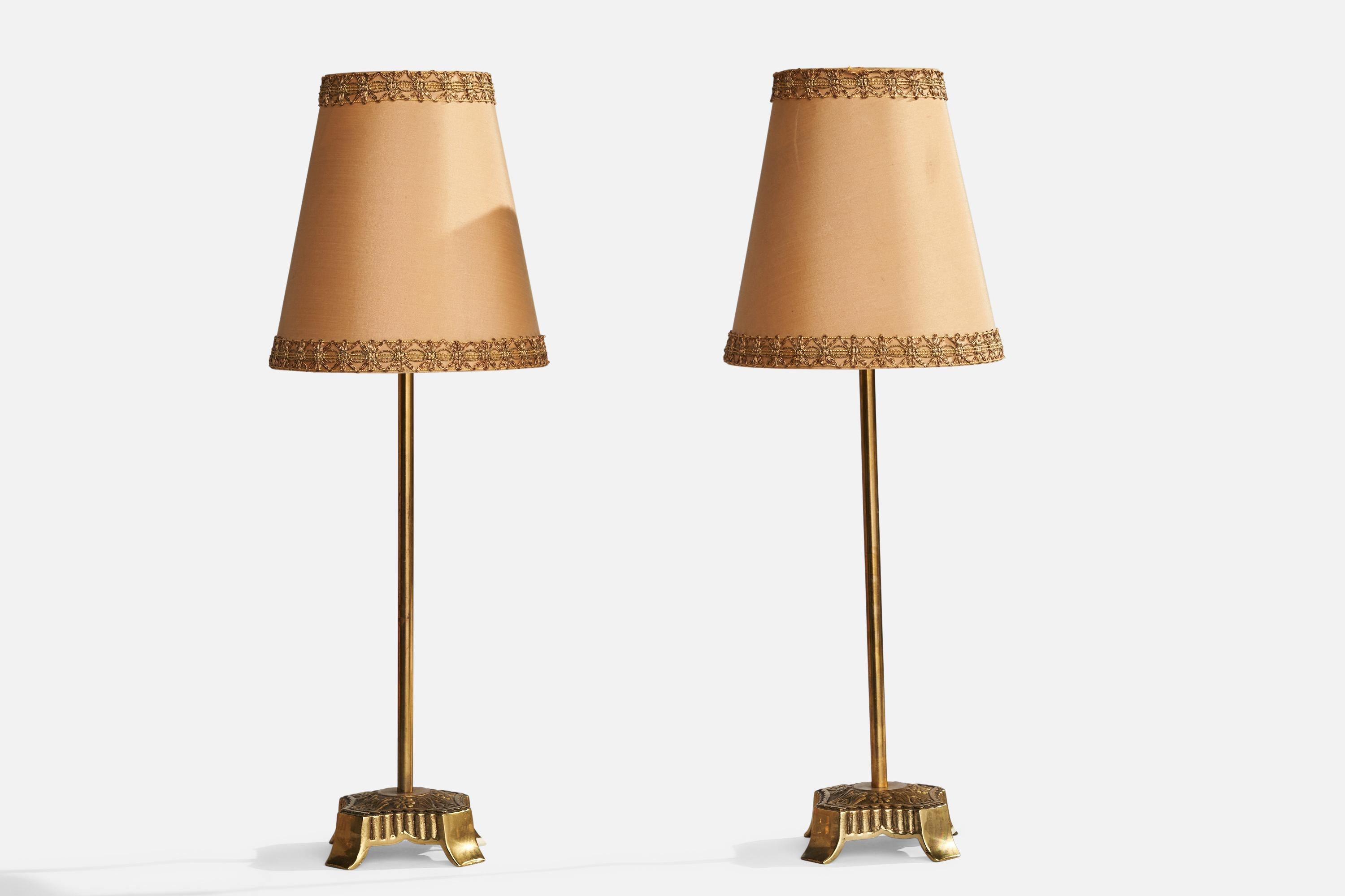 A pair of brass and beige fabric table lamps designed and produced in Sweden, c. 1940s.

Overall Dimensions (inches): 19.75”  H x 6.5”  W x 4”  D
Stated dimensions include shade.
Bulb Specifications: E-26 Bulb
Number of Sockets: 2
All lighting will
