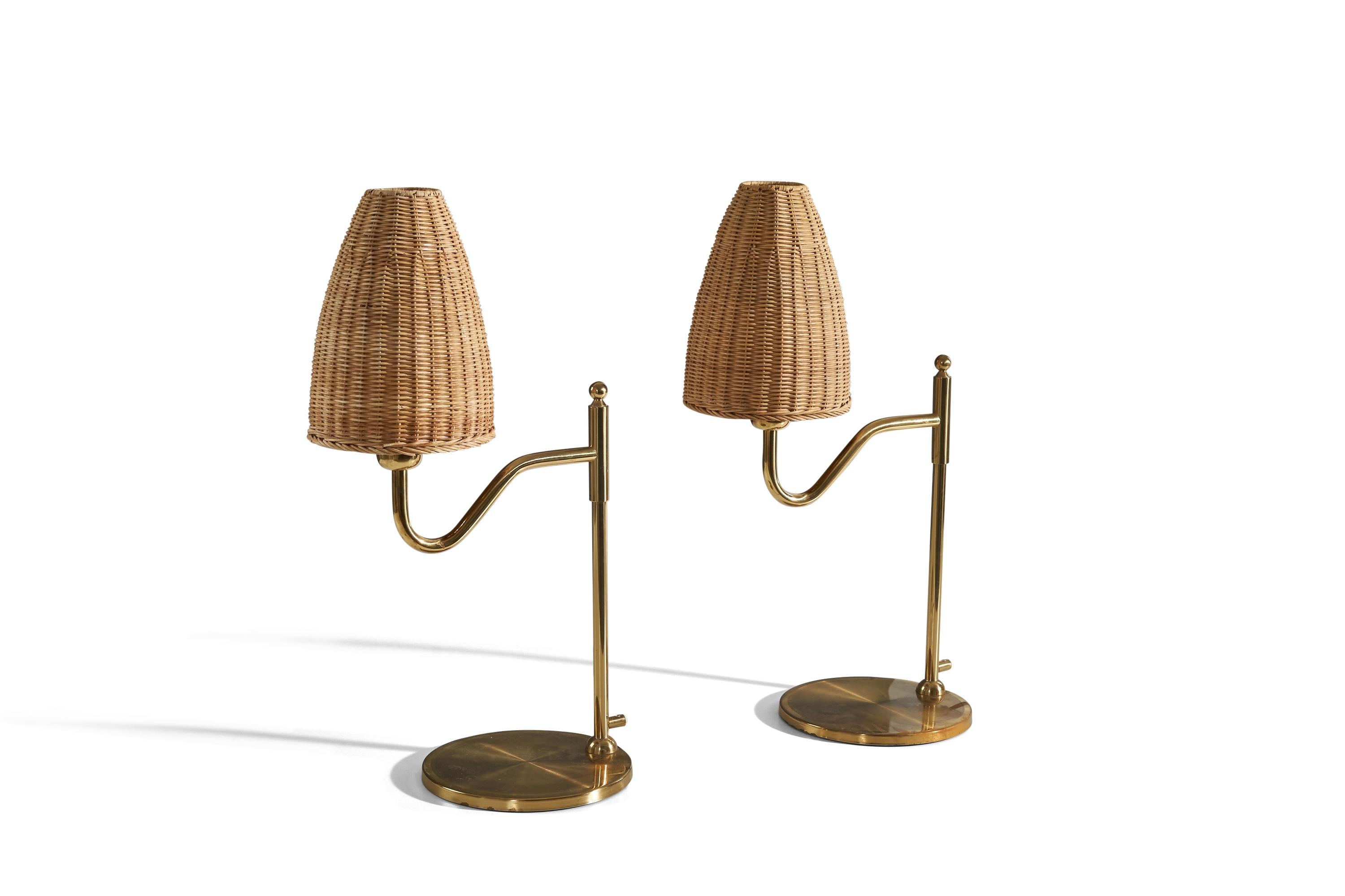 A pair of brass and rattan table lamps designed and produced in Sweden, 1970s. 

Sold with lampshade. 
Dimensions of Lamp (inches) : 18 x 8.62 x 11.5 (H x W x D)
Dimensions of Shade (inches) : 2.43 x 7 x 9.87 (T x B x S)
Dimension of Lamp with