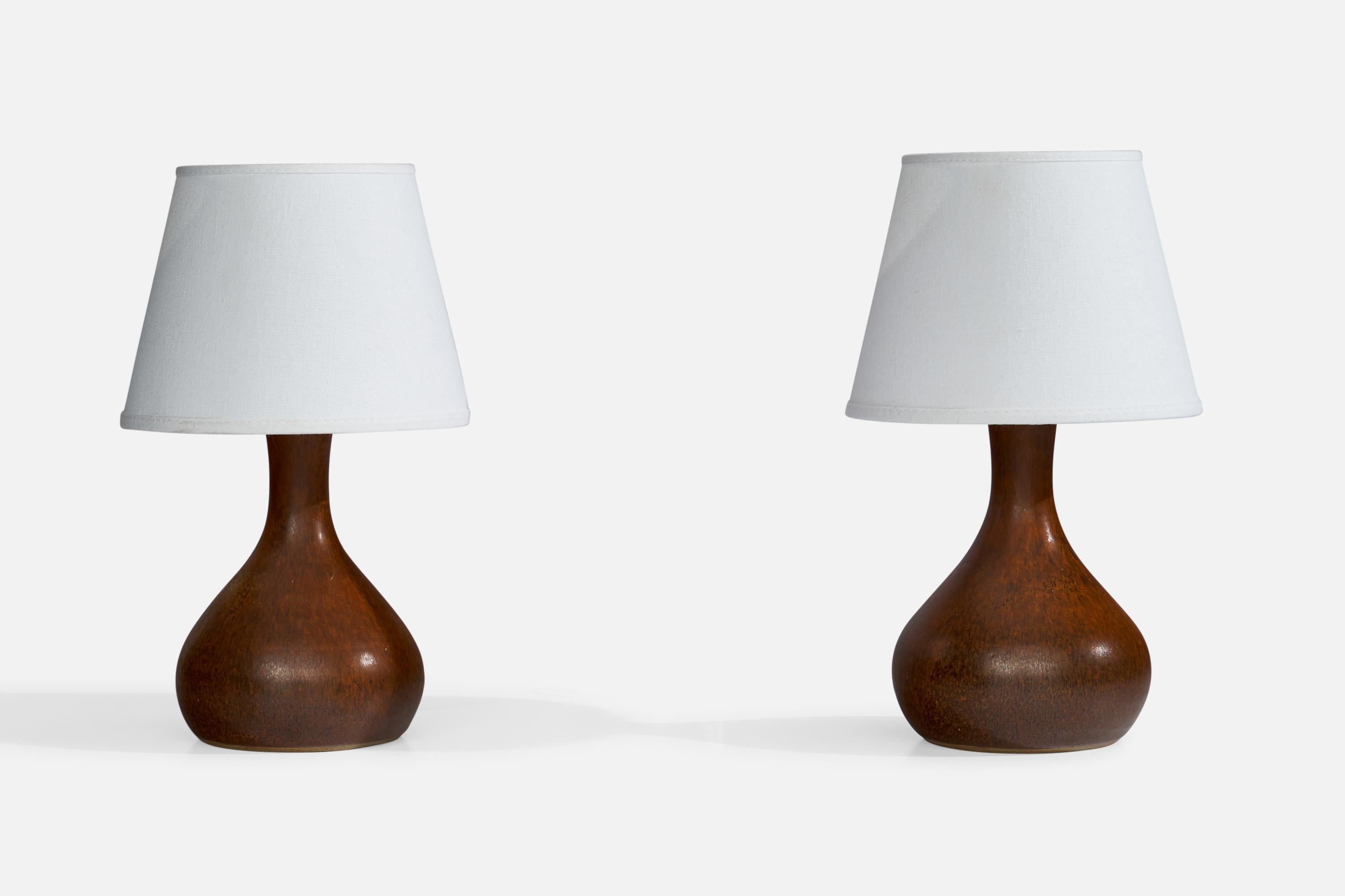 A pair of brown-glazed ceramic table lamps designed and produced in Sweden, c. 1960s.

Dimensions of Lamp (inches): 10.25” H x 5.5” Diameter
Dimensions of Shade (inches): 5.25”  Top Diameter x 8”  Bottom Diameter x 6” H
Dimensions of Lamp with Shade