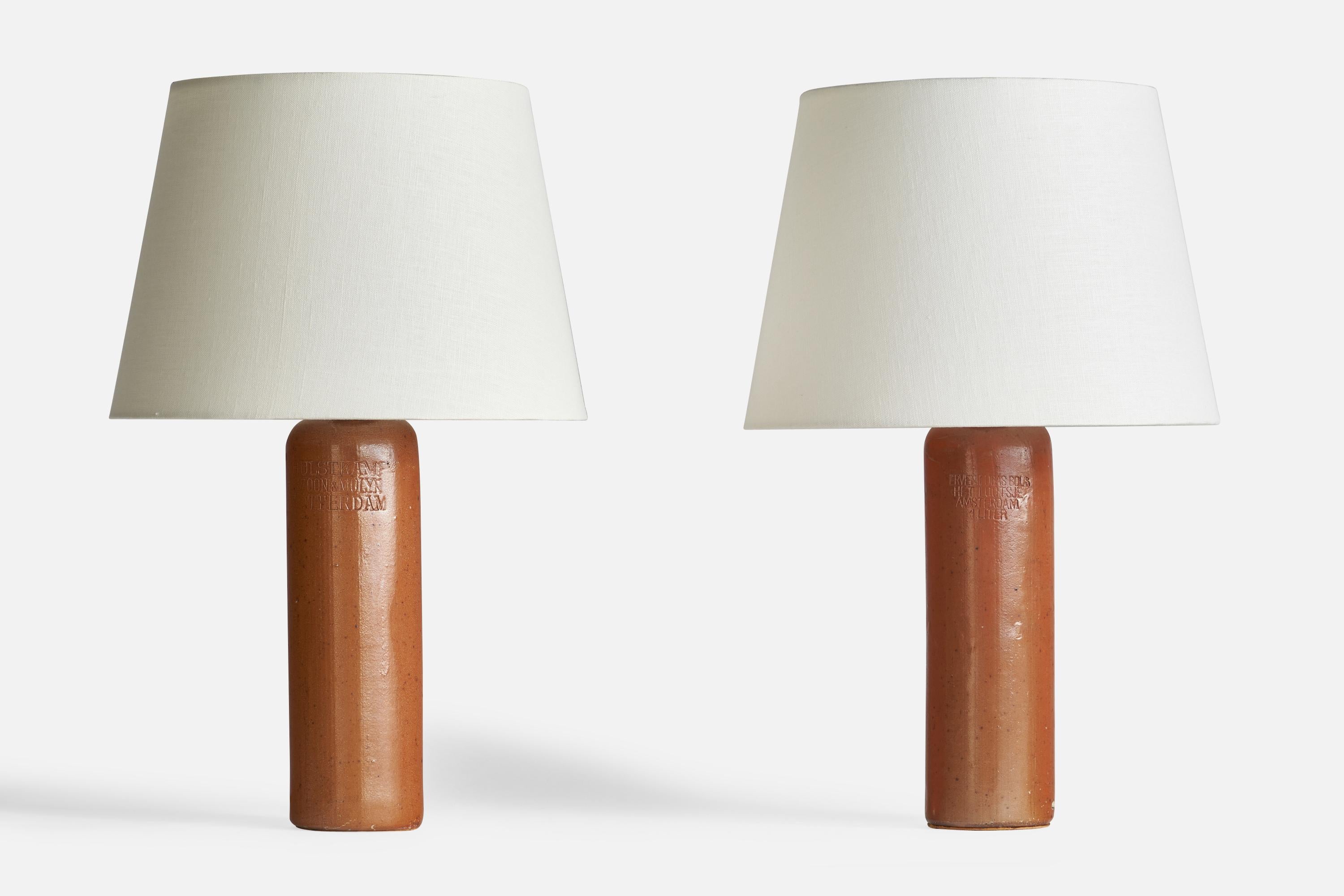 A pair of table lamps produced in Sweden mounted on repurposed Belgian ceramic bottles. 

Dimensions of Lamp (inches): 13.75” H x 3.3” Diameter
Dimensions of Shade (inches): 9” Top Diameter x 12” Bottom Diameter x 9” H
Dimensions of Lamp with Shade
