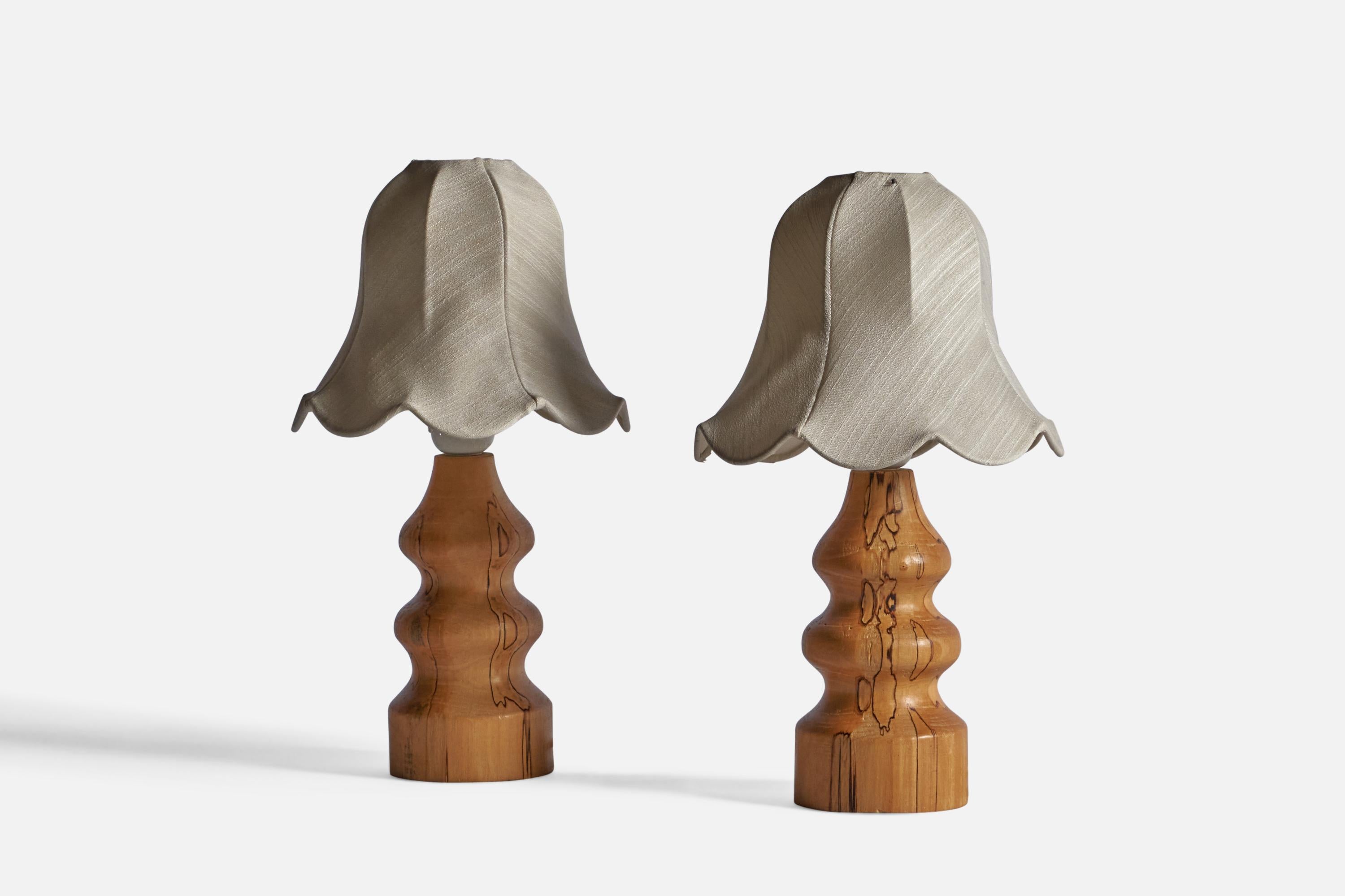A pair of masur birch and fabric table lamps, designed and produced in Sweden, c. 1960s.

Sold with Lampshades.

Dimensions stated are of table lamps with Lampshades attached.