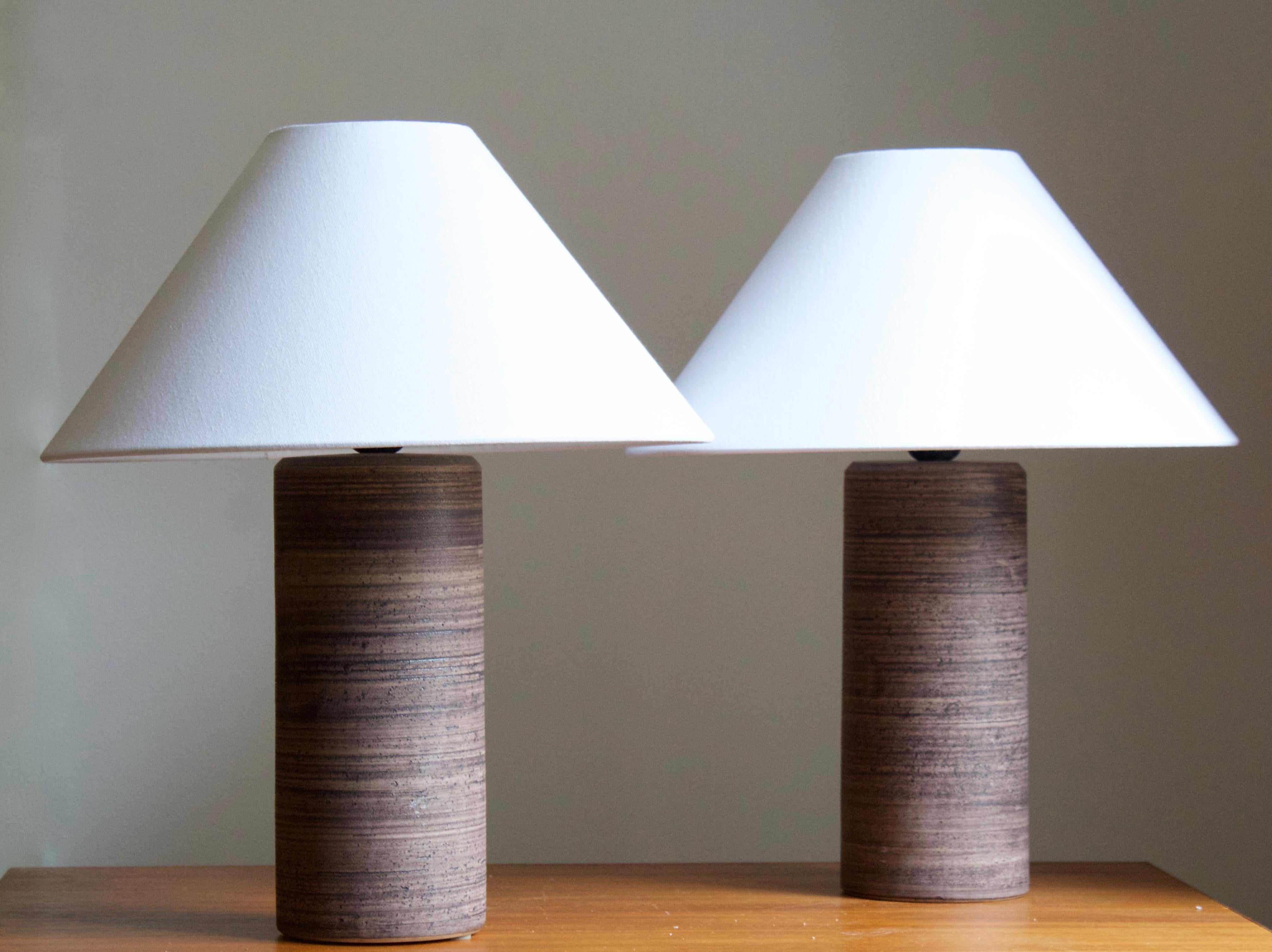 A pair of table lamps, designed and produced in Sweden, 1950s-1960s. In incised and glazed stoneware.