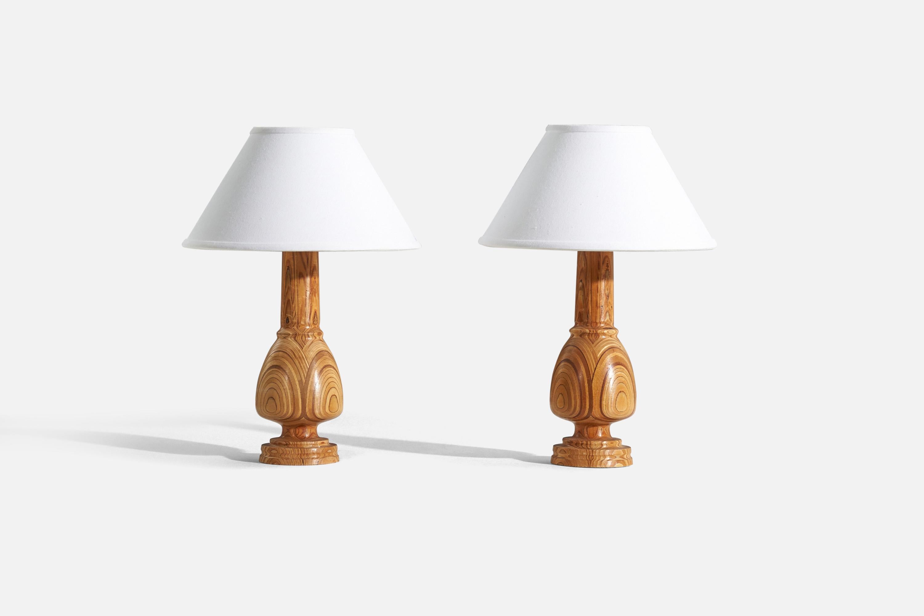 A pair of laminated wood table lamps, designed and produced in Sweden, 1976.

Sold without lampshade. 
Dimensions of lamp (inches) : 14.3125 x 4.5 x 4.5 (H x W x D)
Dimensions of shade (inches) : 5 x 12.25 x 7.25 (T x B x H)
Dimension of lamp