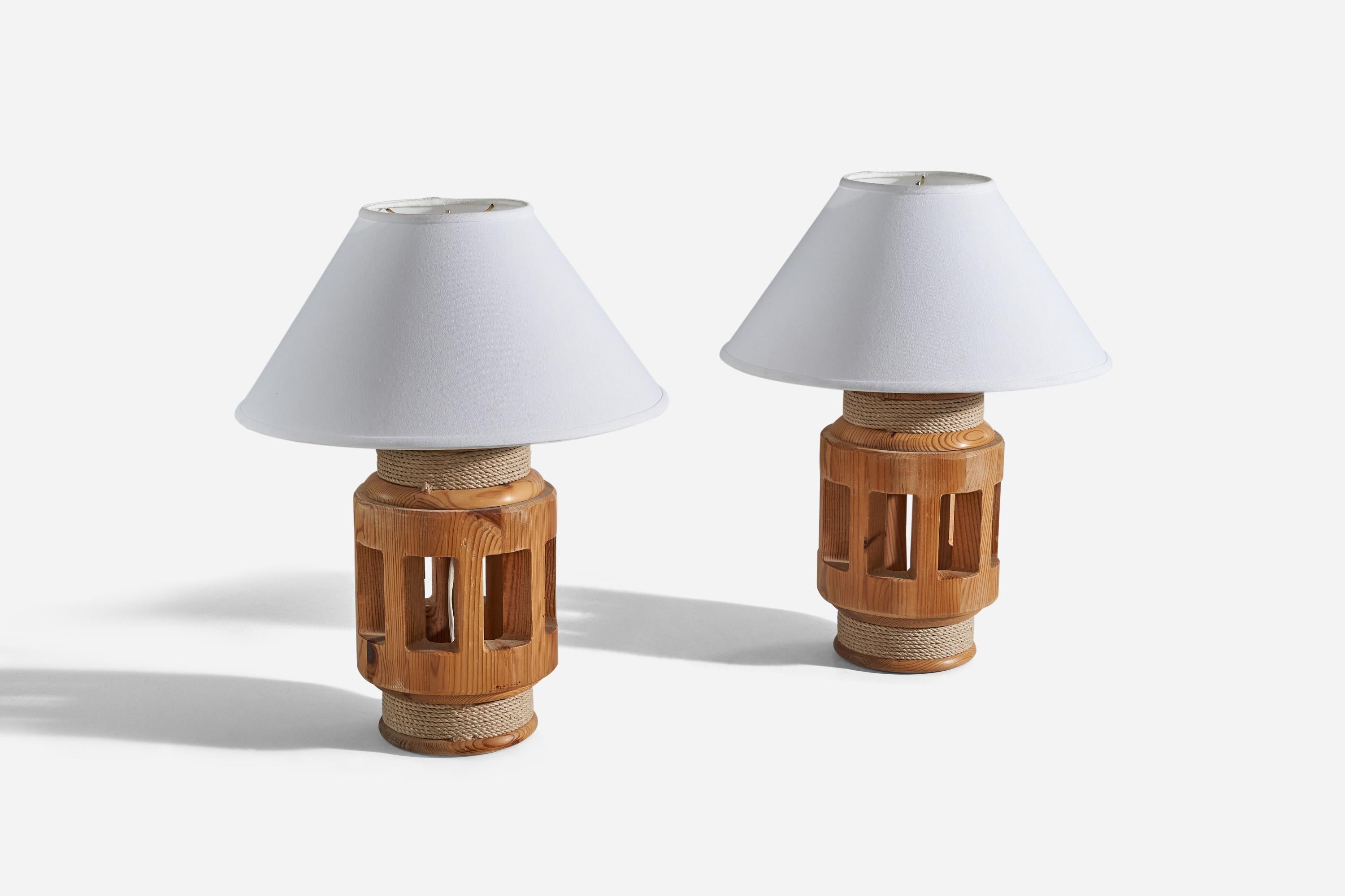 A pair of pine and cord table lamps designed and produced in Sweden, 1970s. 

Sold without lampshade. 
Dimensions of Lamp (inches) : 15.37 x 7.62 x 7.62 (H x W x D)
Dimensions of Shade (inches) : 6.25 x 16.37 x 9.12 (T x B x S)
Dimension of
