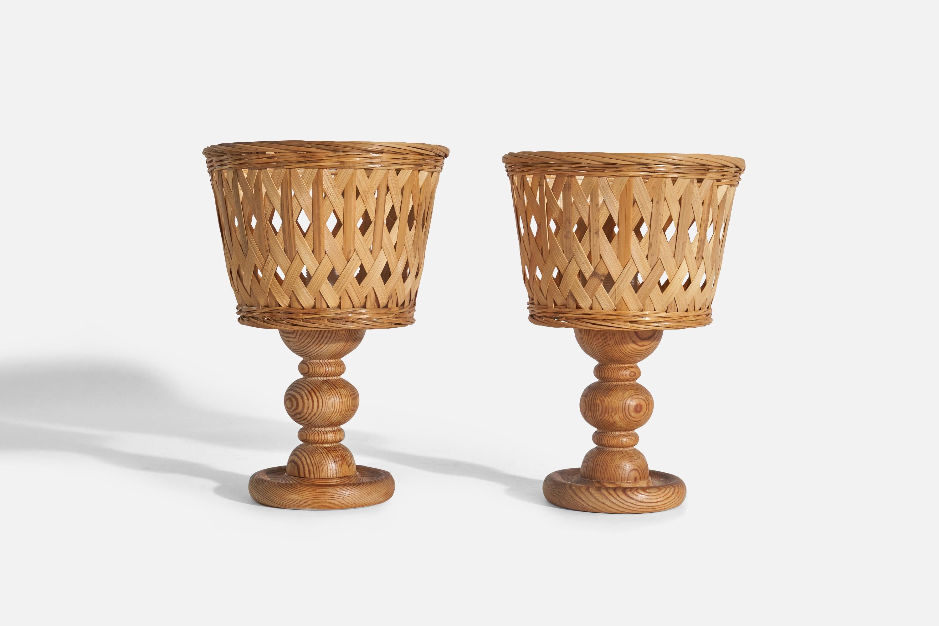 A pair of pine and rattan table lamps designed and produced in Sweden, 1970s.

Sold with Lampshade(s). 
Stated dimensions refer to the Lamp with the Shade(s). 

Socket takes E-14 bulb.
There is no maximum wattage stated on the fixture.
