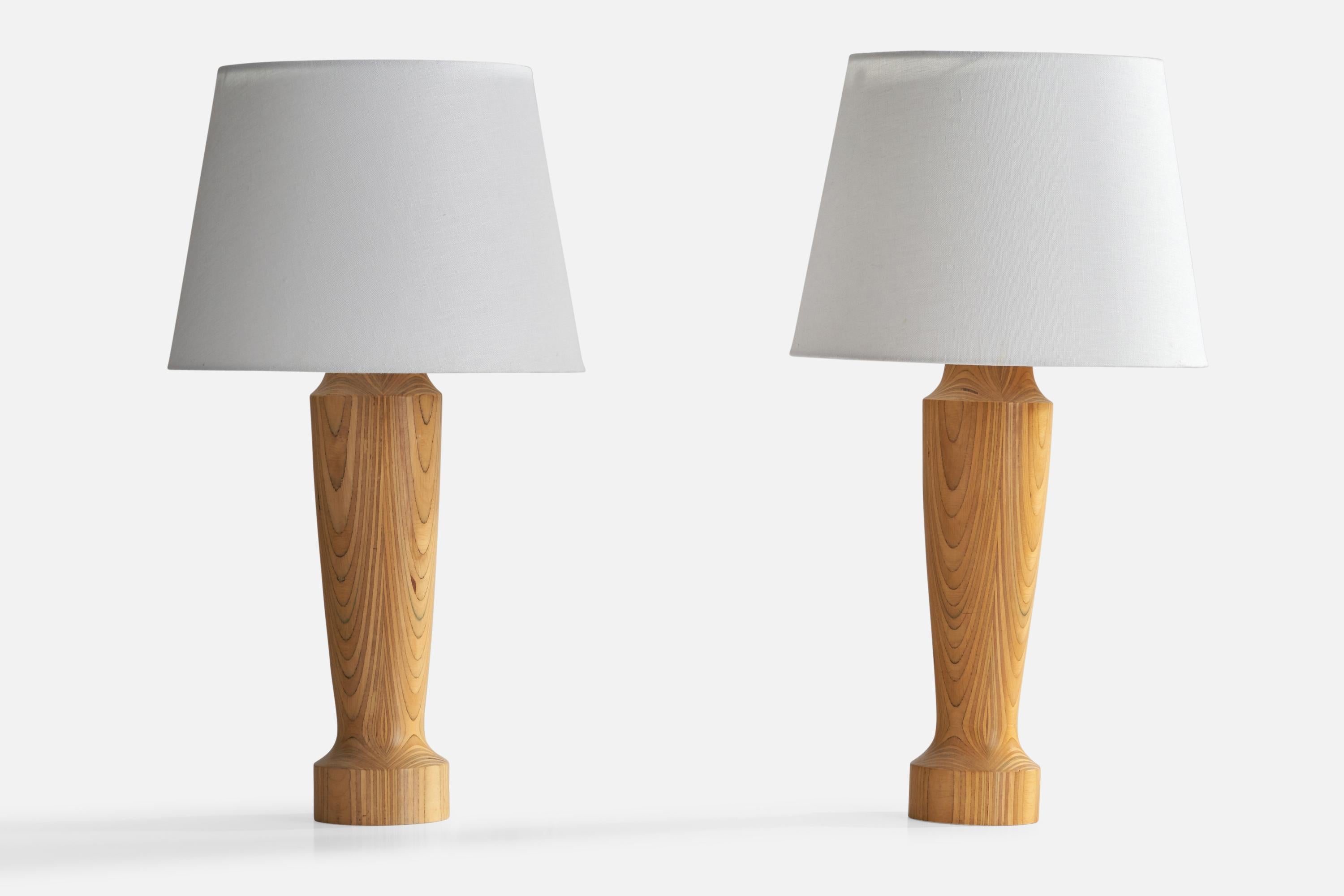 A pair of stack-laminated pine table lamps designed and produced in Sweden, 1960s.

Dimensions of Lamp (inches): 16.9”  H x 3.9”  Diameter
Dimensions of Shade (inches): 9”  Top Diameter x 12”  Bottom Diameter x 8.75” H
Dimensions of Lamp with Shade
