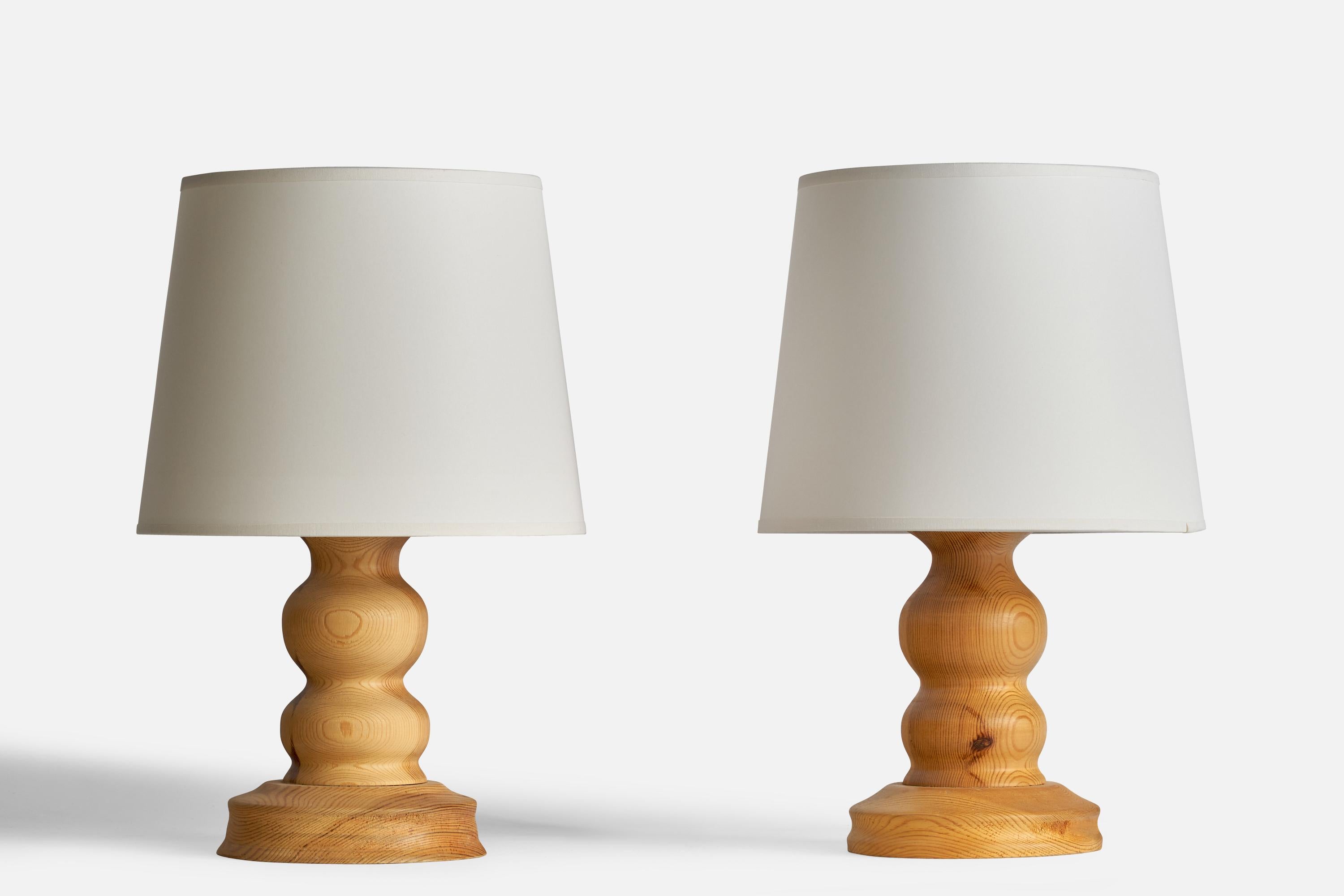 A pair of of pine table lamps designed and produced in Sweden, 1970s.

Note lamp bases are not identical in form.

Dimensions of Lamp (inches): 10.5” H x 6” Diameter
Dimensions of Shade (inches): 8” Top Diameter x 10” Bottom Diameter x 8”
