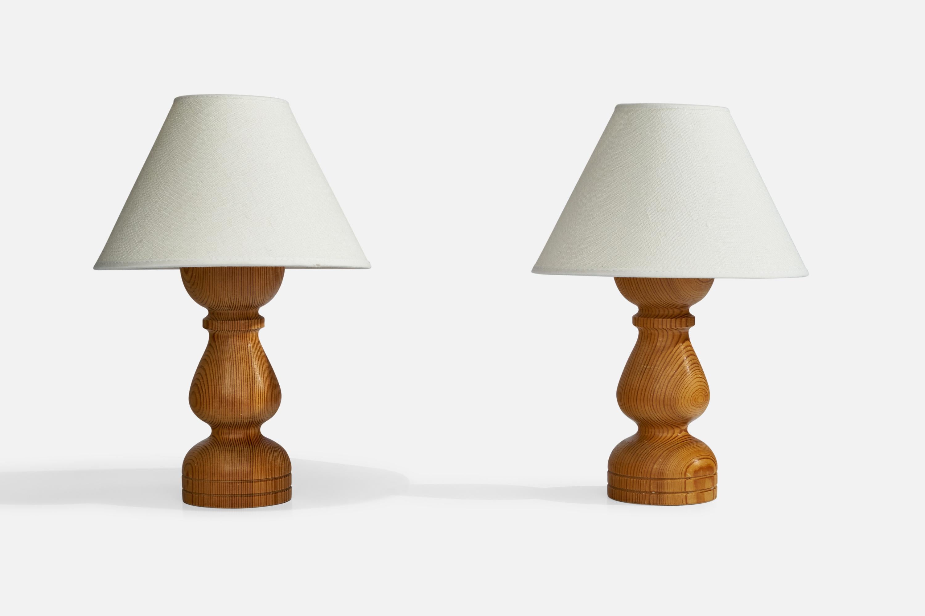 A pair of pine table lamps designed and produced in Sweden, 1970s.

Dimensions of Lamp (inches): 8.5”  H x 3” Diameter
Dimensions of Shade (inches): 3”  Top Diameter x 8” Bottom Diameter x 5.5” H
Dimensions of Lamp with Shade (inches): 11.5” H x 8”