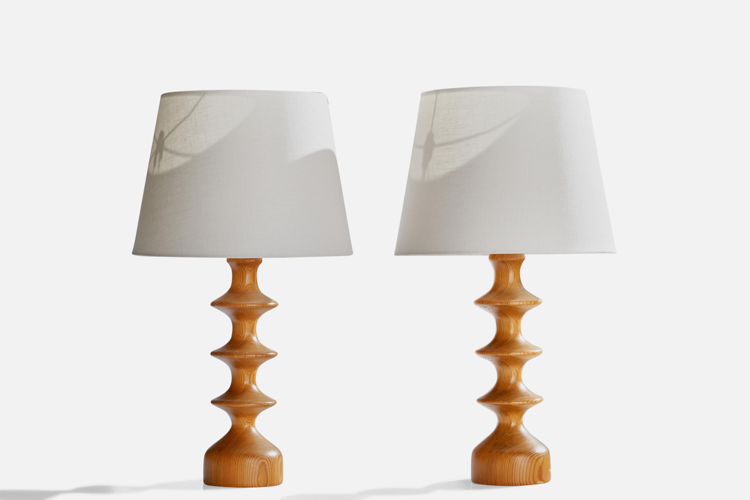 A pair of pine table lamps designed and produced in Sweden, c. 1970s.

Dimensions of Lamp (inches): 16”  H x 4.5” Diameter
Dimensions of Shade (inches): 9”  Top Diameter x 12” Bottom Diameter x 9” H
Dimensions of Lamp with Shade (inches): 21”  H x