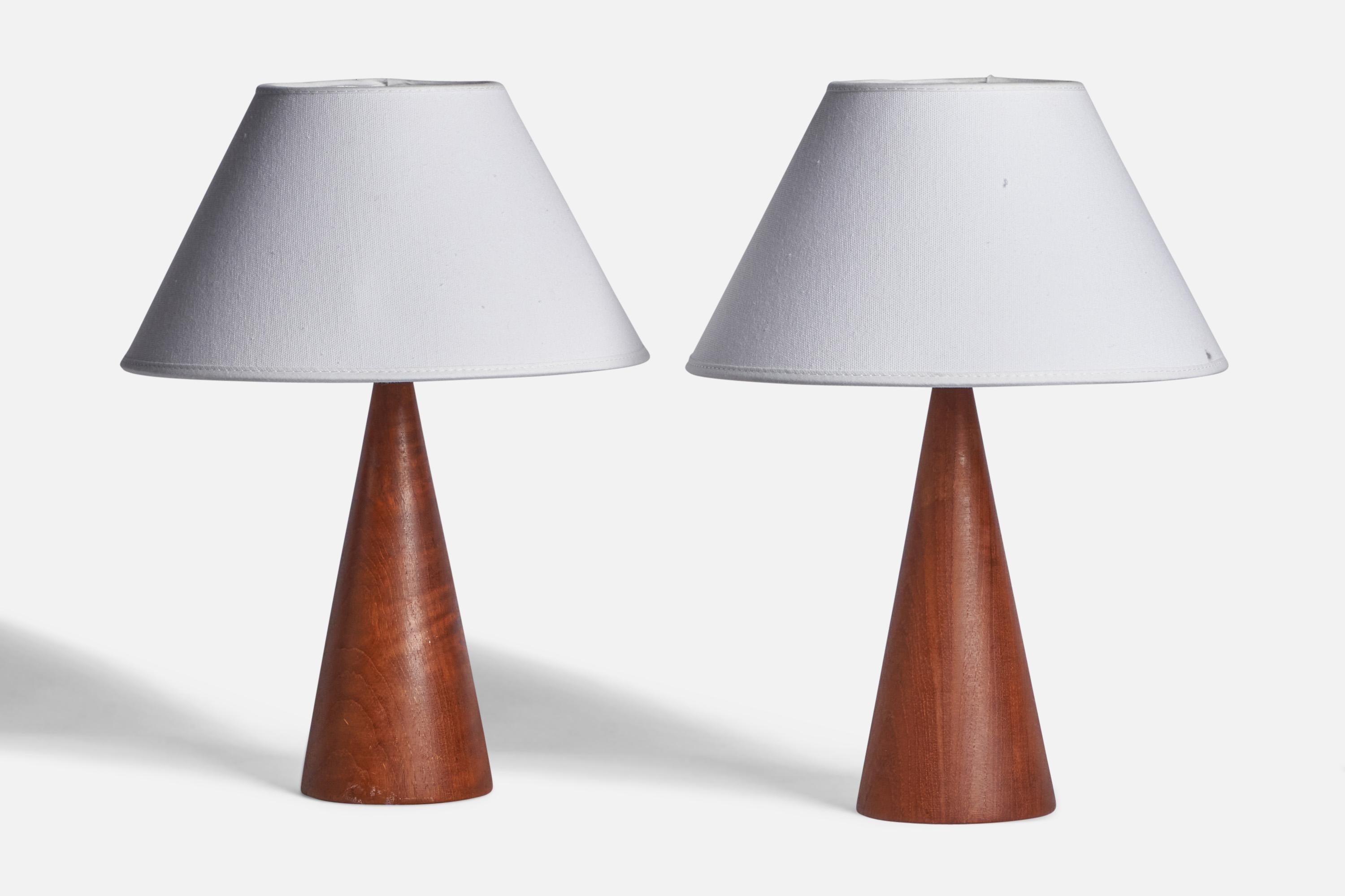 
A pair of teak table lamp designed and produced in Sweden, c. 1950s.
Dimensions of Lamp (inches): 12.75” H x 5.80” Diameter
Dimensions of Shade (inches): 4.5” Top Diameter x 10” Bottom Diameter x 5.5” H 
Dimensions of Lamp with Shade (inches):
