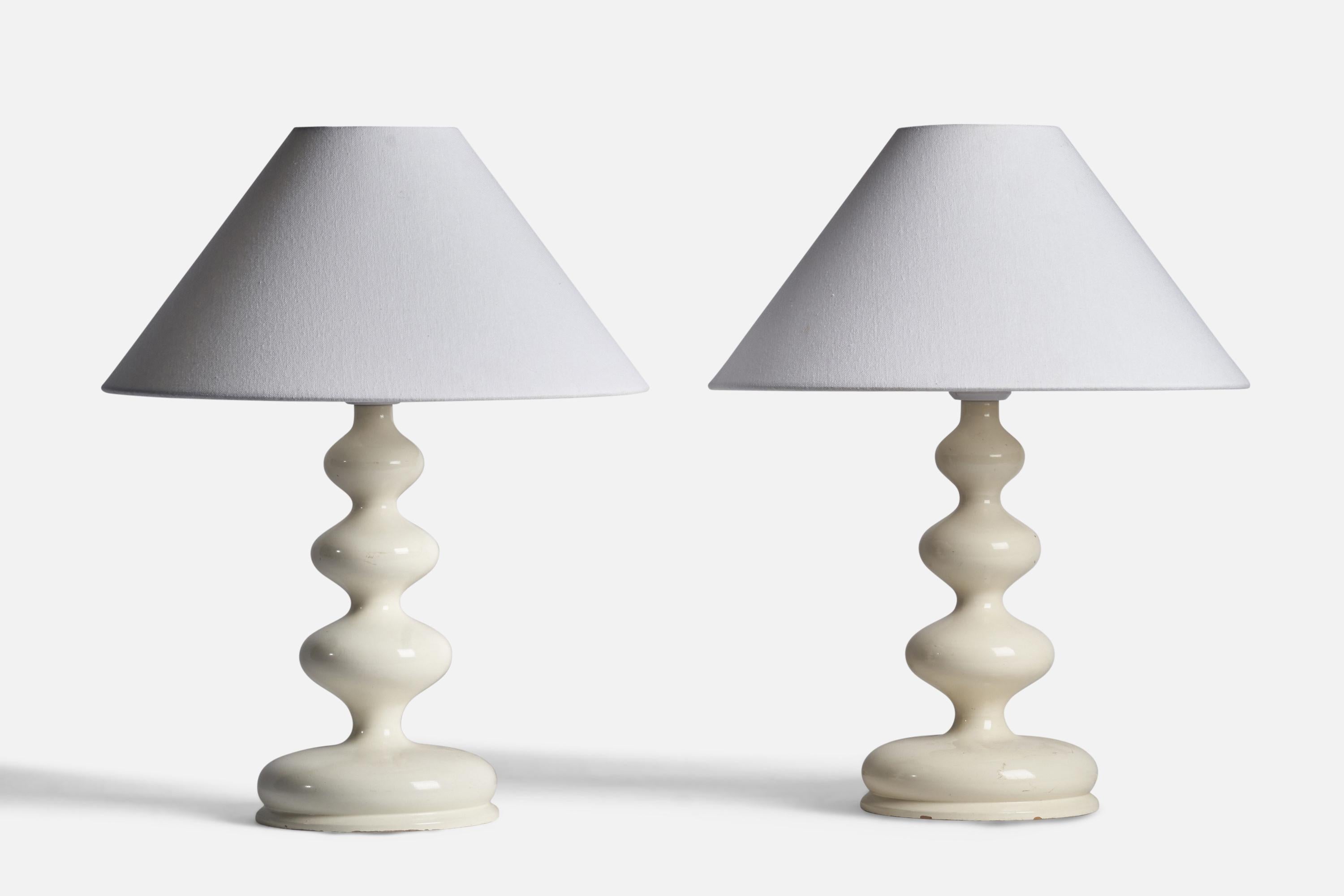 A pair of cream-white lacquered table lamps designed and produced in Sweden, 1960s.

Dimensions of Lamp (inches): 15” H x 7” Diameter
Dimensions of Shade (inches): 4.5” Top Diameter x 15.75” Bottom Diameter x 9.25” H
Dimensions of Lamp with Shade