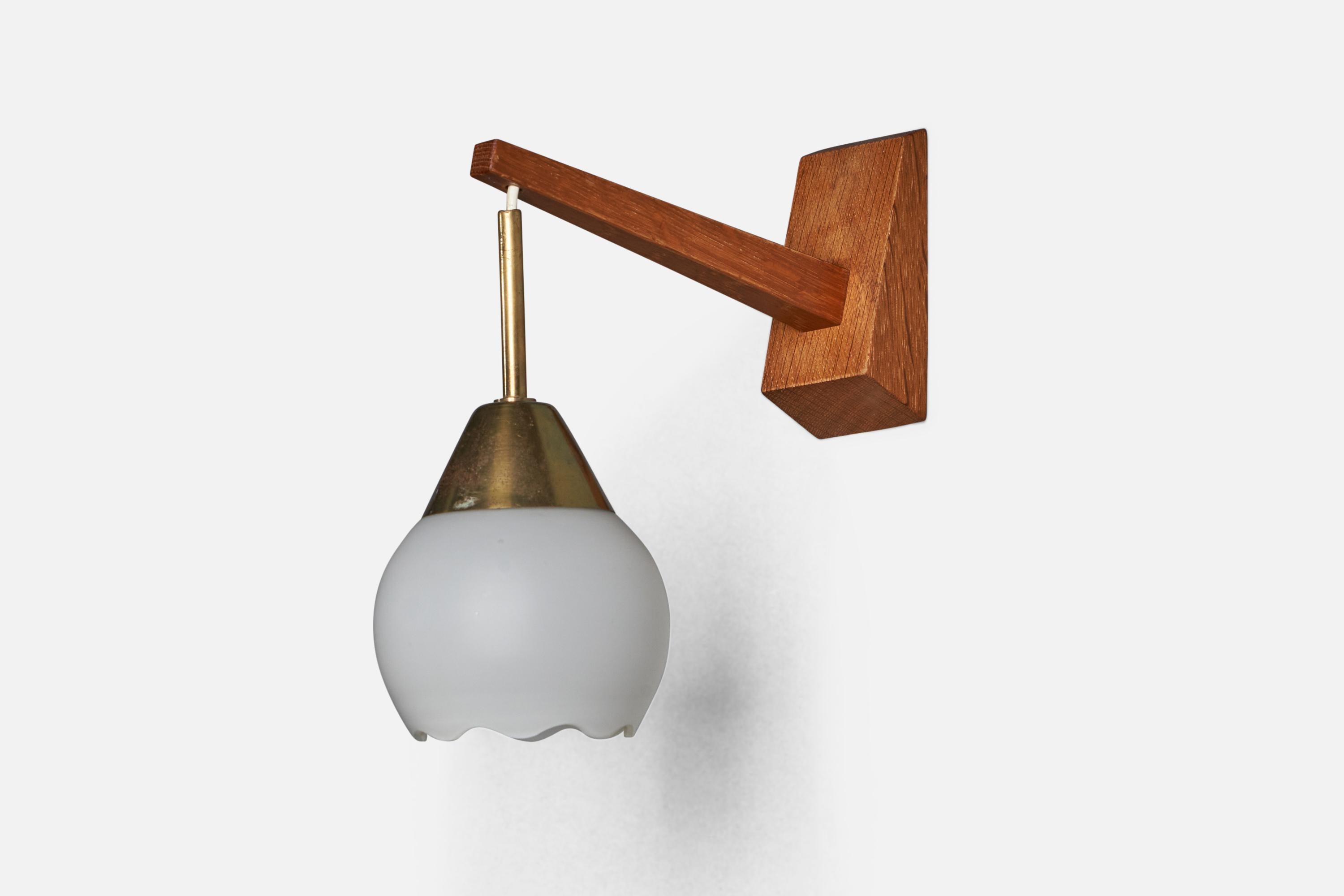 An adjustable teak, brass and opaline glass wall light designed and produced in Sweden, 1940s.

Overall Dimensions (inches): 10” H x 3.75” W x 9” D
Back Plate Dimensions (inches): 4” H x 2.15” W x 1” D
Bulb Specifications: E-26 Bulb
Number of