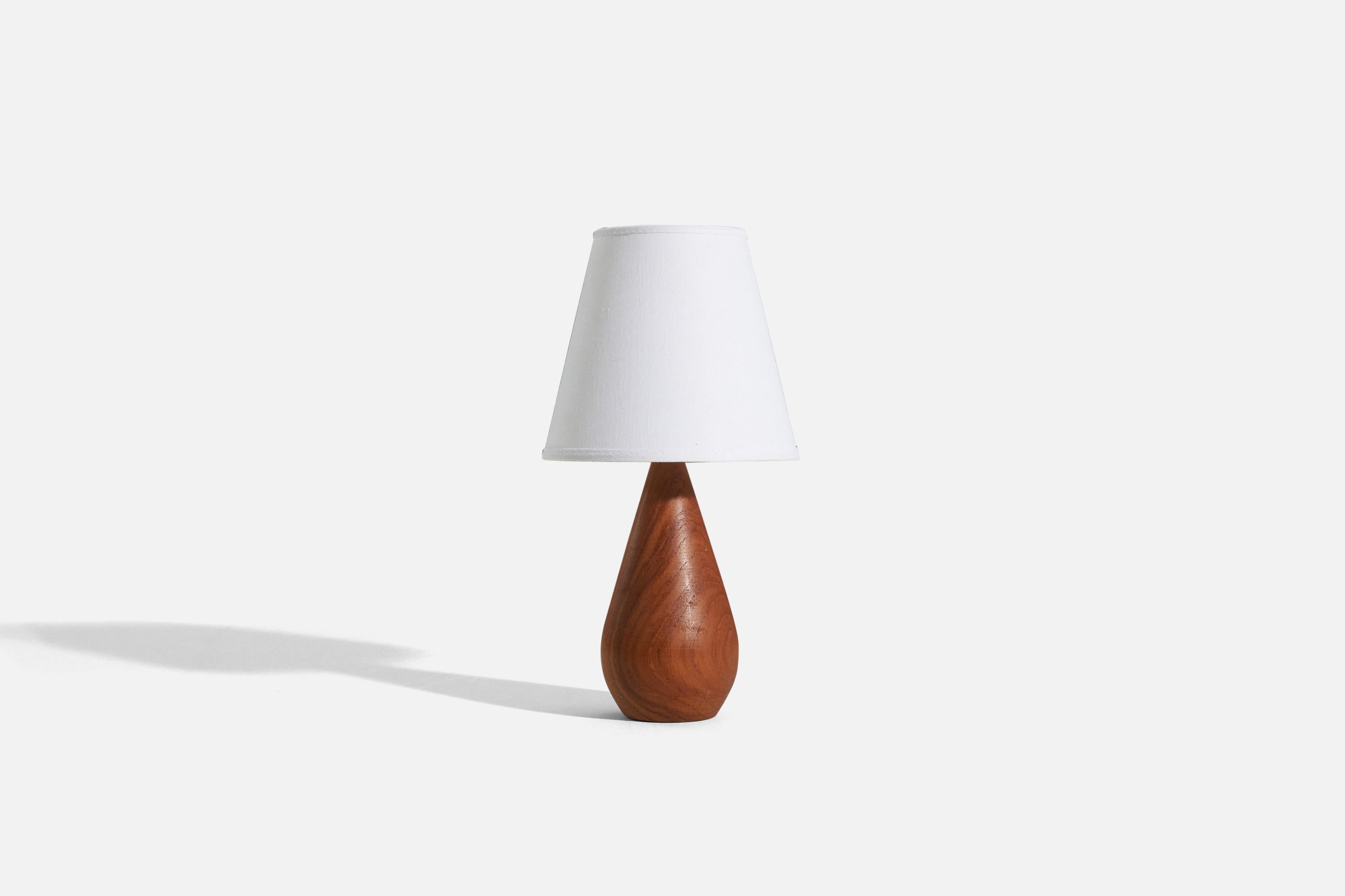 A teak table lamp designed and produced by a Swedish designer, Sweden, 1960s.

Sold without lampshade. 
Dimensions of Lamp (inches) : 9.625 x 3.625 x 3.625 (H x W x D)
Dimensions of Shade (inches) : 4 x 7 x 6.25 (T x B x H)
Dimension of Lamp