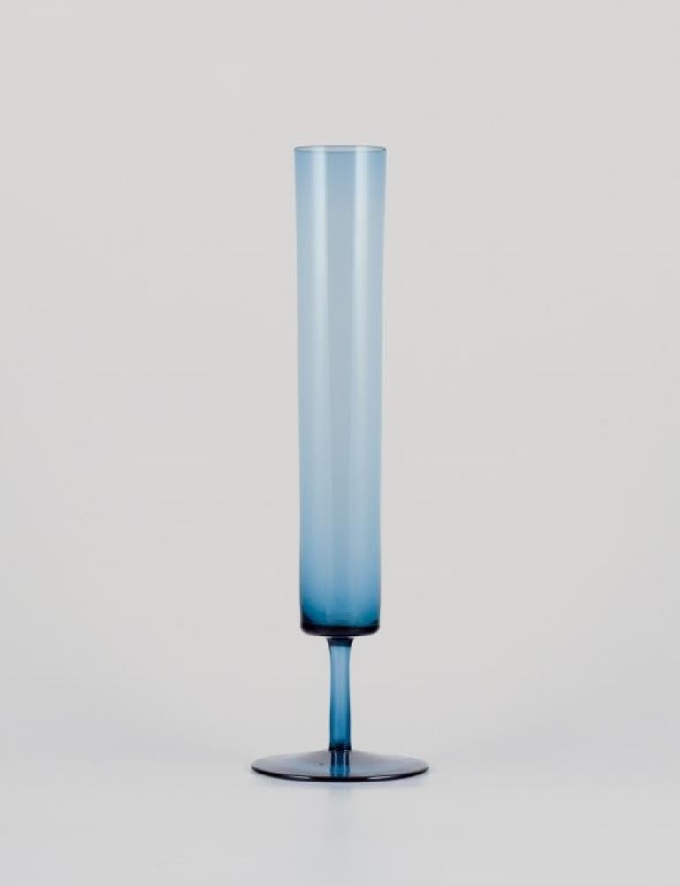 Swedish designer, three vases in art glass crafted in a slim design.
Blue mouth-blown glass.
Approximately from the 1970s.
In perfect condition.
The largest measures: 36.0 cm x D 10.0 cm.