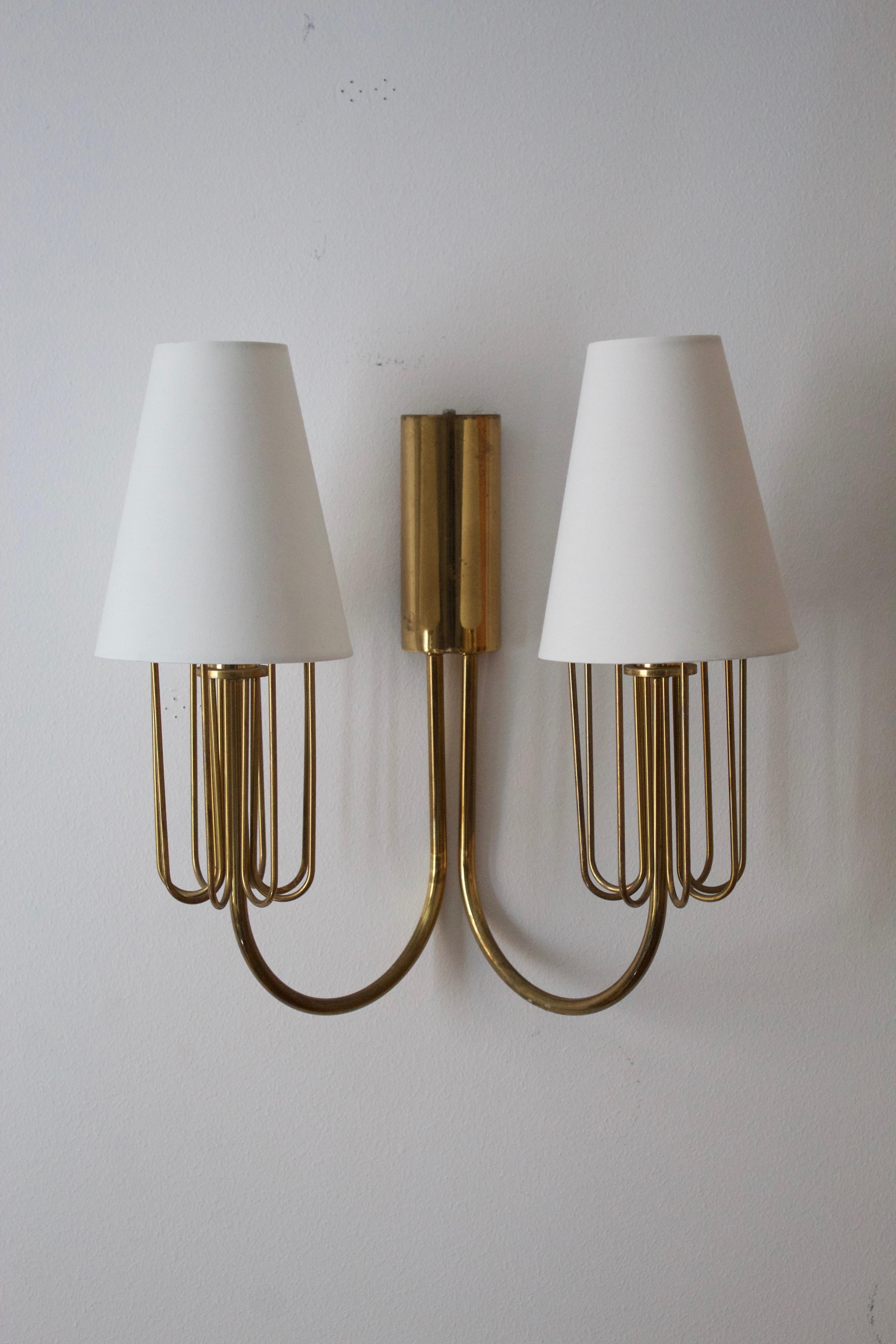A two armed wall light / sconce. Designed and produced in Sweden, c. 1950s. 

   

Brand new high-end lampshades.

Other designers of the period include Paavo Tynell, Jean Royère, Hans Bergström, Hans-Agne Jakobsson, and Kaare Klint.