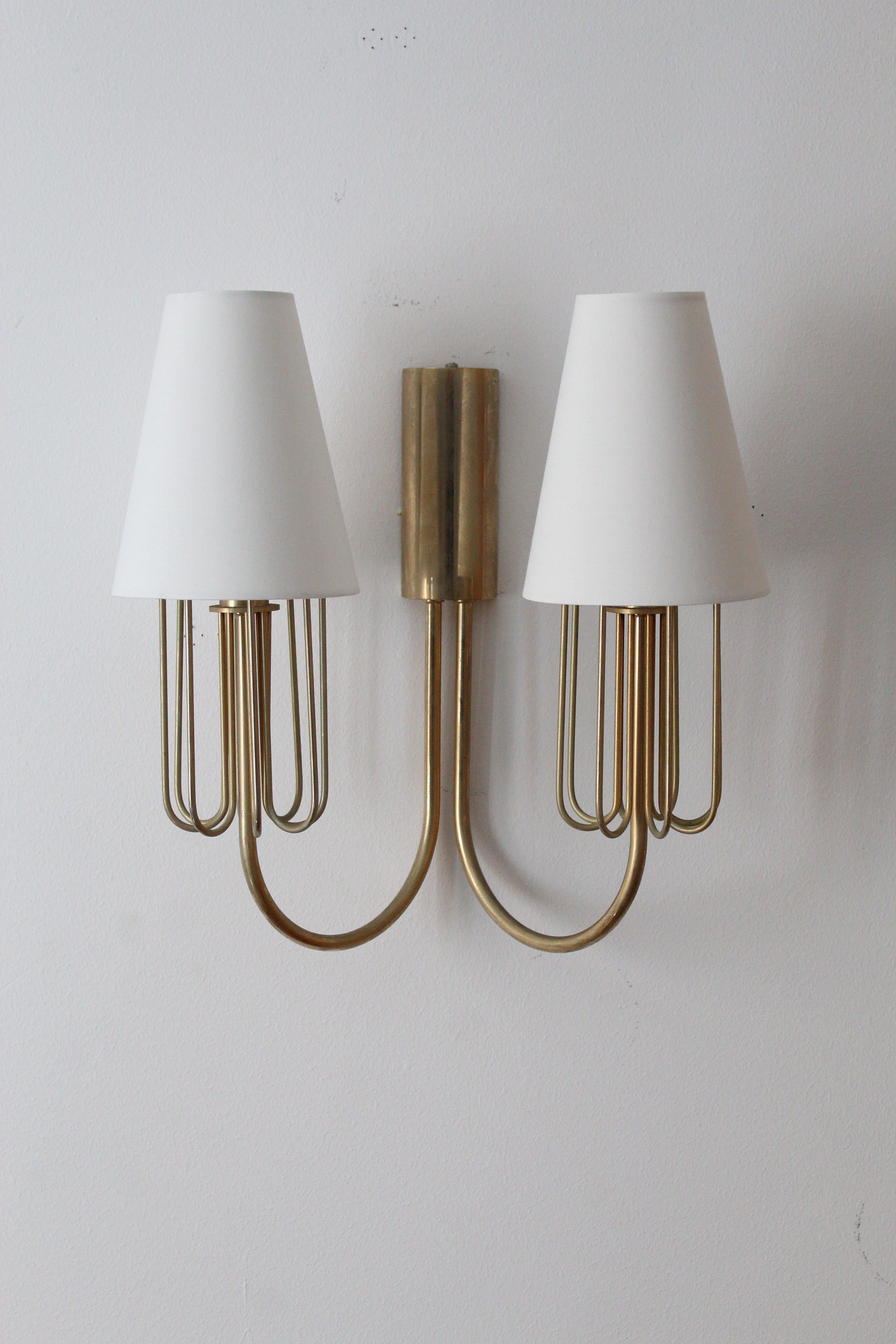 A two armed wall light / sconce. Designed and produced in Sweden, c. 1950s. 

Brand new high-end lampshades.

Other designers of the period include Paavo Tynell, Jean Royère, Hans Bergström, Hans-Agne Jakobsson, and Kaare Klint.

    