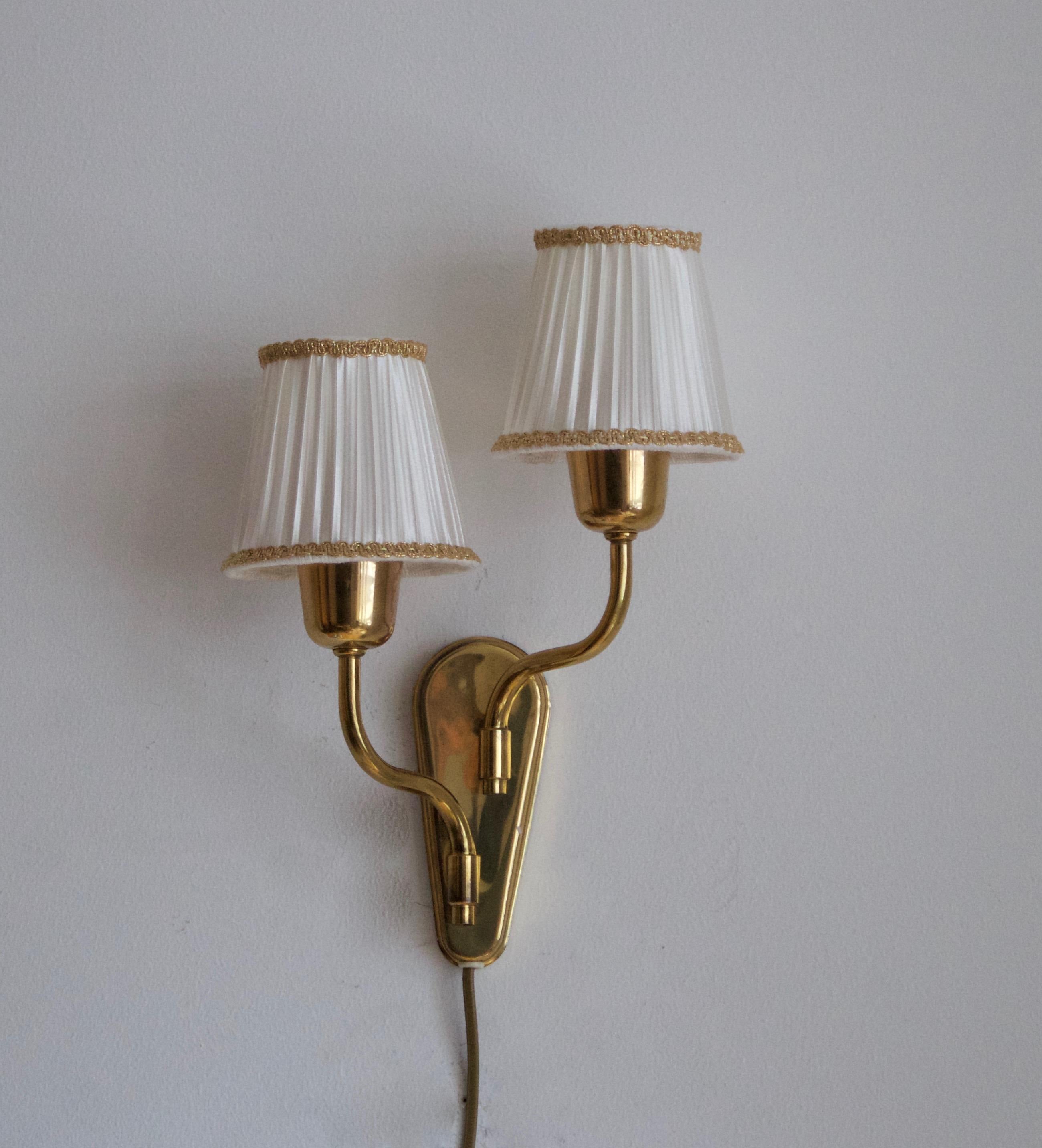 A two armed wall light / sconce. Designed and produced in Sweden, c. 1950s.

Brand new high-end lampshades.

Other designers of the period include Paavo Tynell, Jean Royère, Hans Bergström, Hans-Agne Jakobsson, and Kaare Klint.