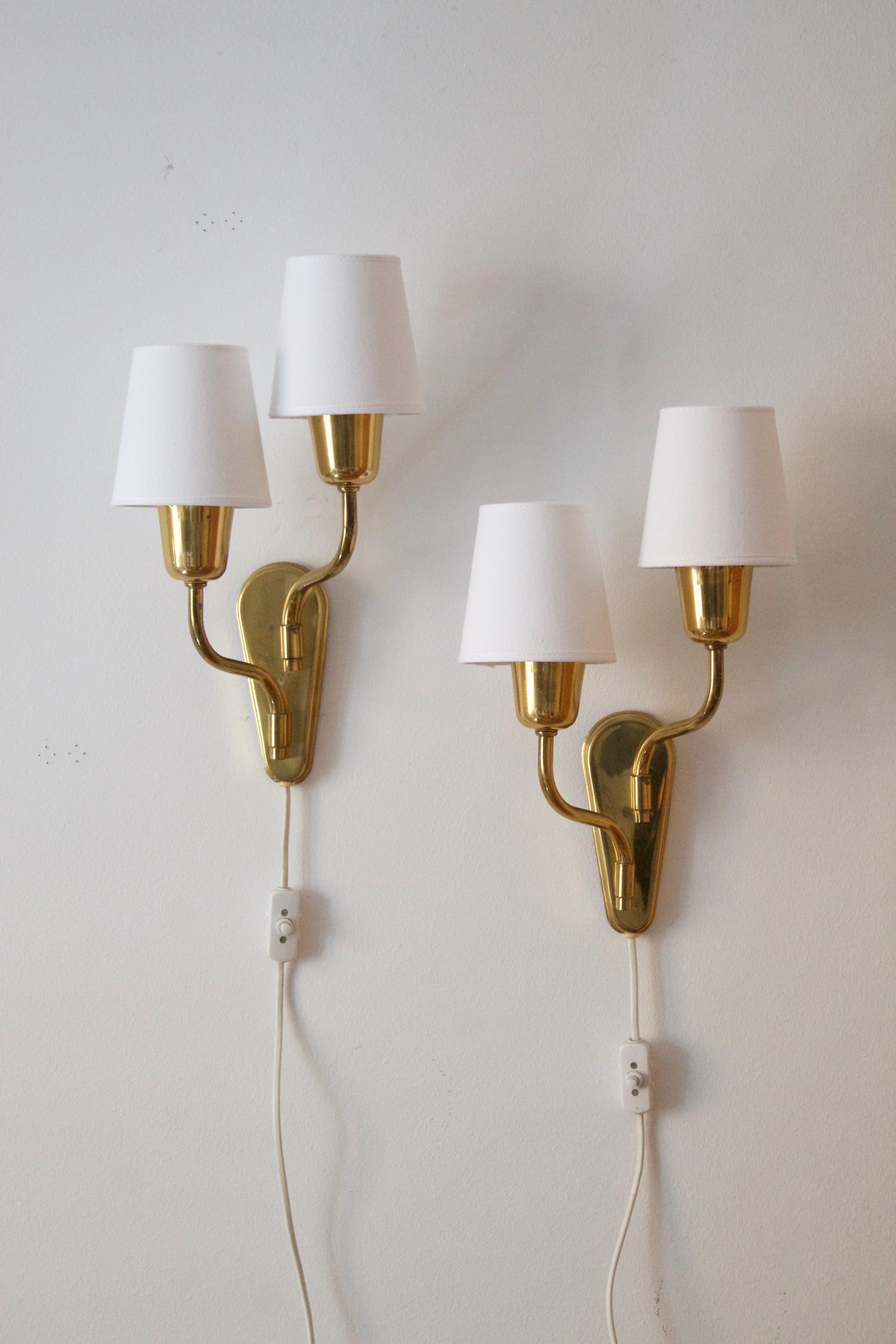 A two armed wall lights / sconces. Designed and produced in Sweden, c. 1950s.

Brand new high-end lampshades.

Other designers of the period include Paavo Tynell, Jean Royère, Hans Bergström, Hans-Agne Jakobsson, and Kaare Klint.