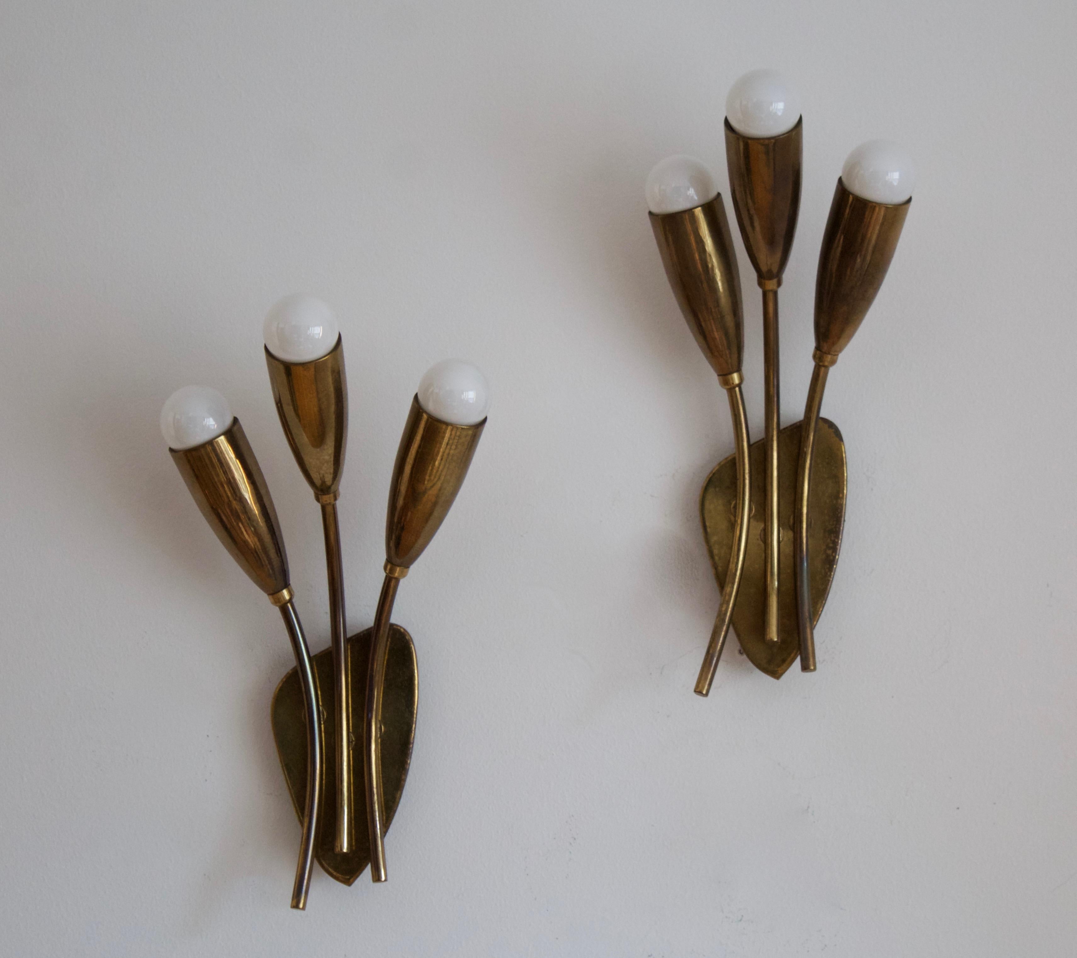 A pair of two-armed wall lights. designed and produced in Sweden, 1950s. Can also function as flush mount ceiling light.

Stated dimensions with lightbulbs attached.