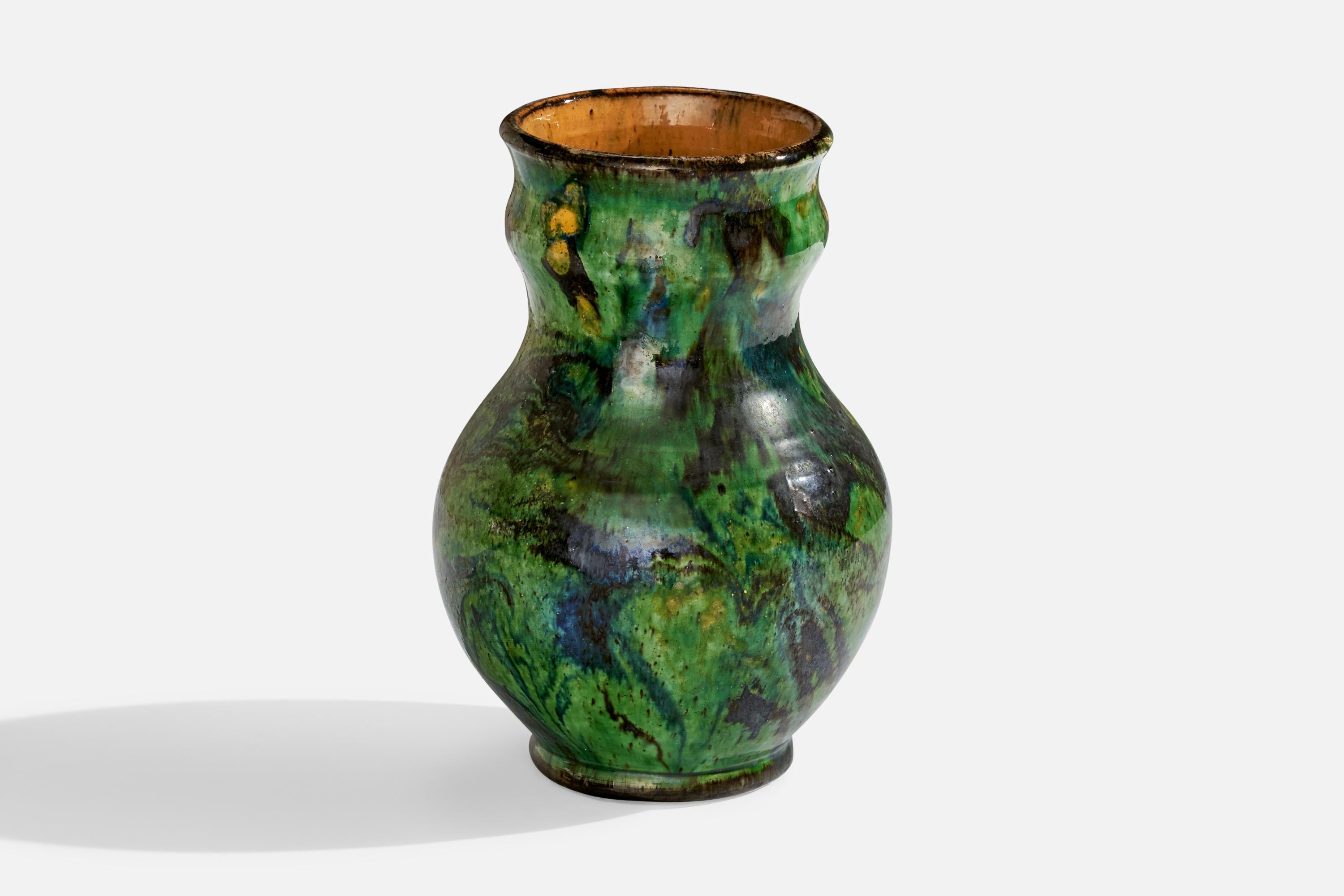 A green-painted and glazed ceramic vase designed and produced in Sweden, 1933.