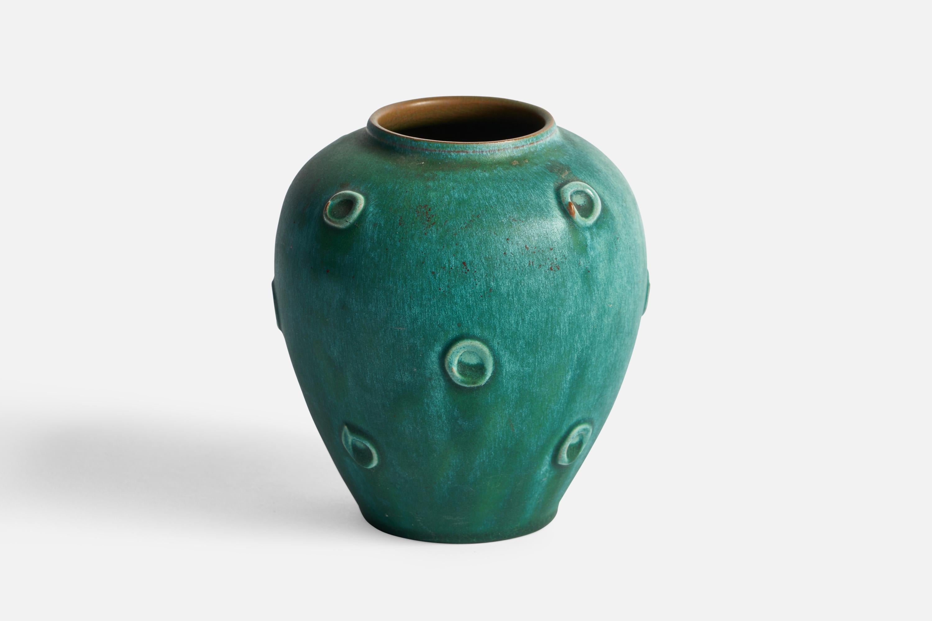 A green-glazed ceramic vase designed and produced in Sweden, c. 1950s.
