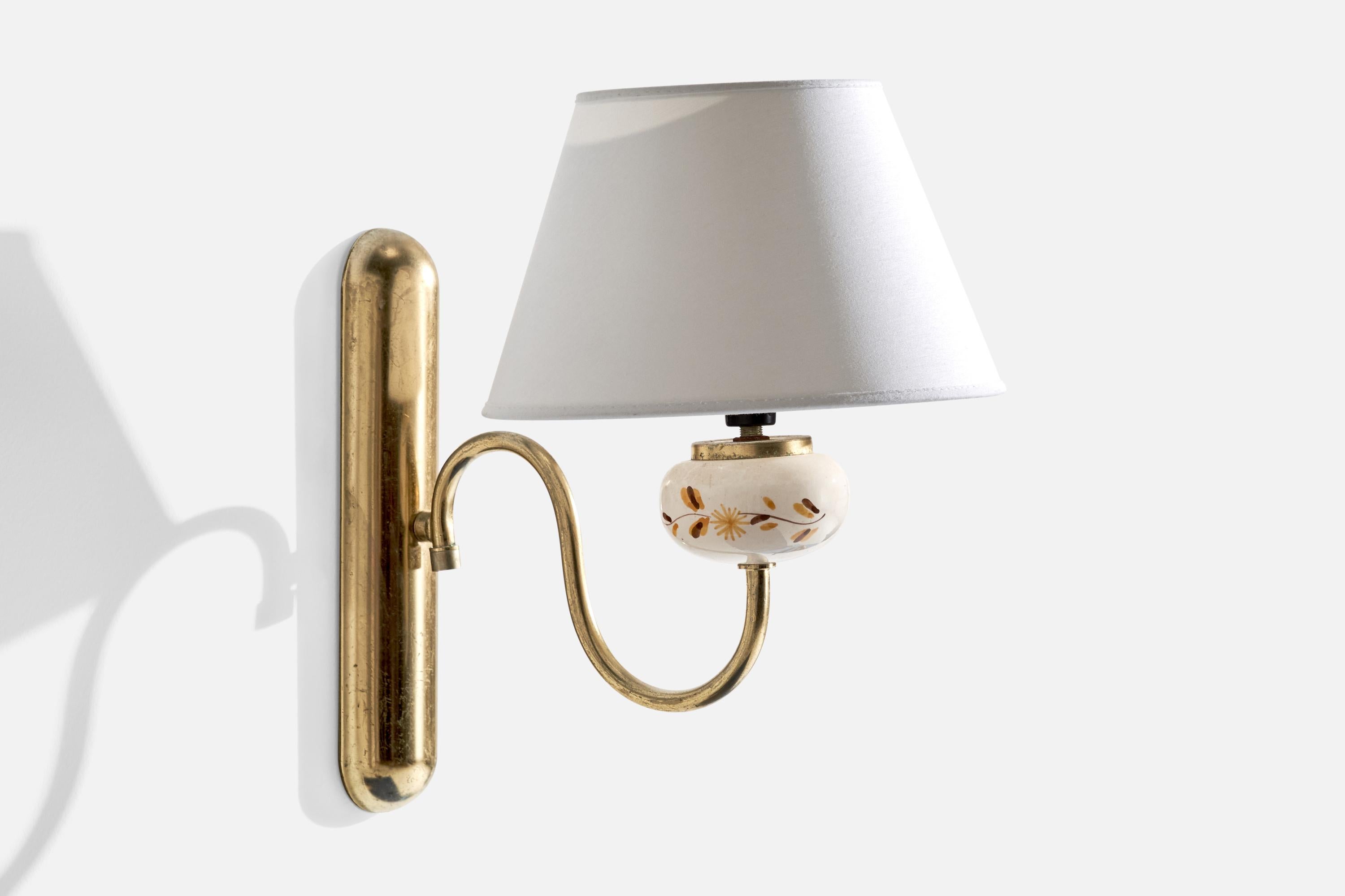 A brass, fabric and hand-painted ceramic wall light designed and produced in Sweden, c. 1950s.

Overall Dimensions (inches):  12.5” H x  8.5” W x  11.75“D
Back Plate Dimensions (Inches):  10” H x 2.125” W x 1” D
Bulb Specifications: E-14
