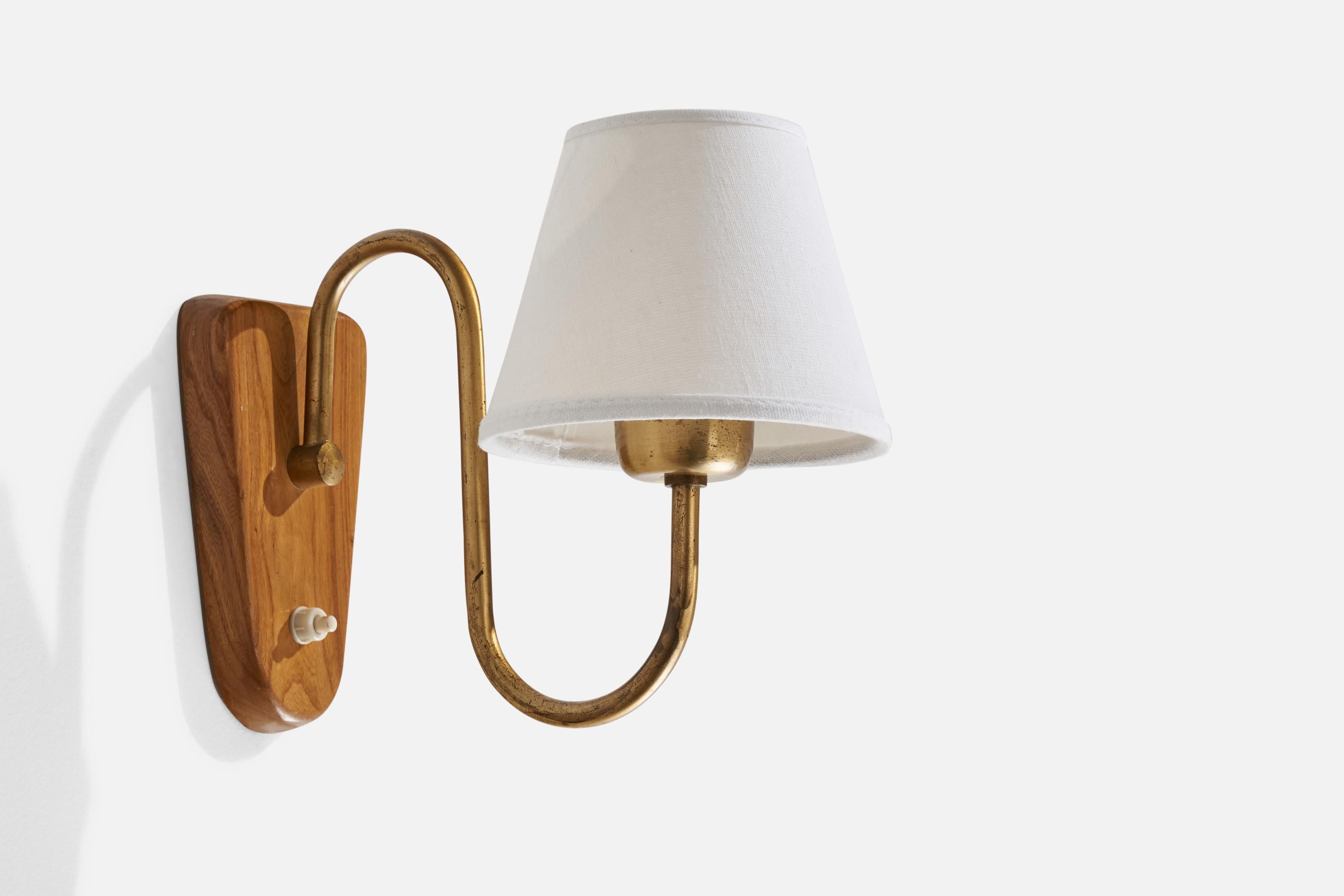 A brass, elm and white fabric wall light designed and produced in Sweden, 1940s.

Overall Dimensions (inches): 9” H x 5.75” W x 9.5” D
Back Plate Dimensions (inches): 6.25” H x 3.64” W x 0.73” D
Bulb Specifications: E-26 Bulb
Number of Sockets: