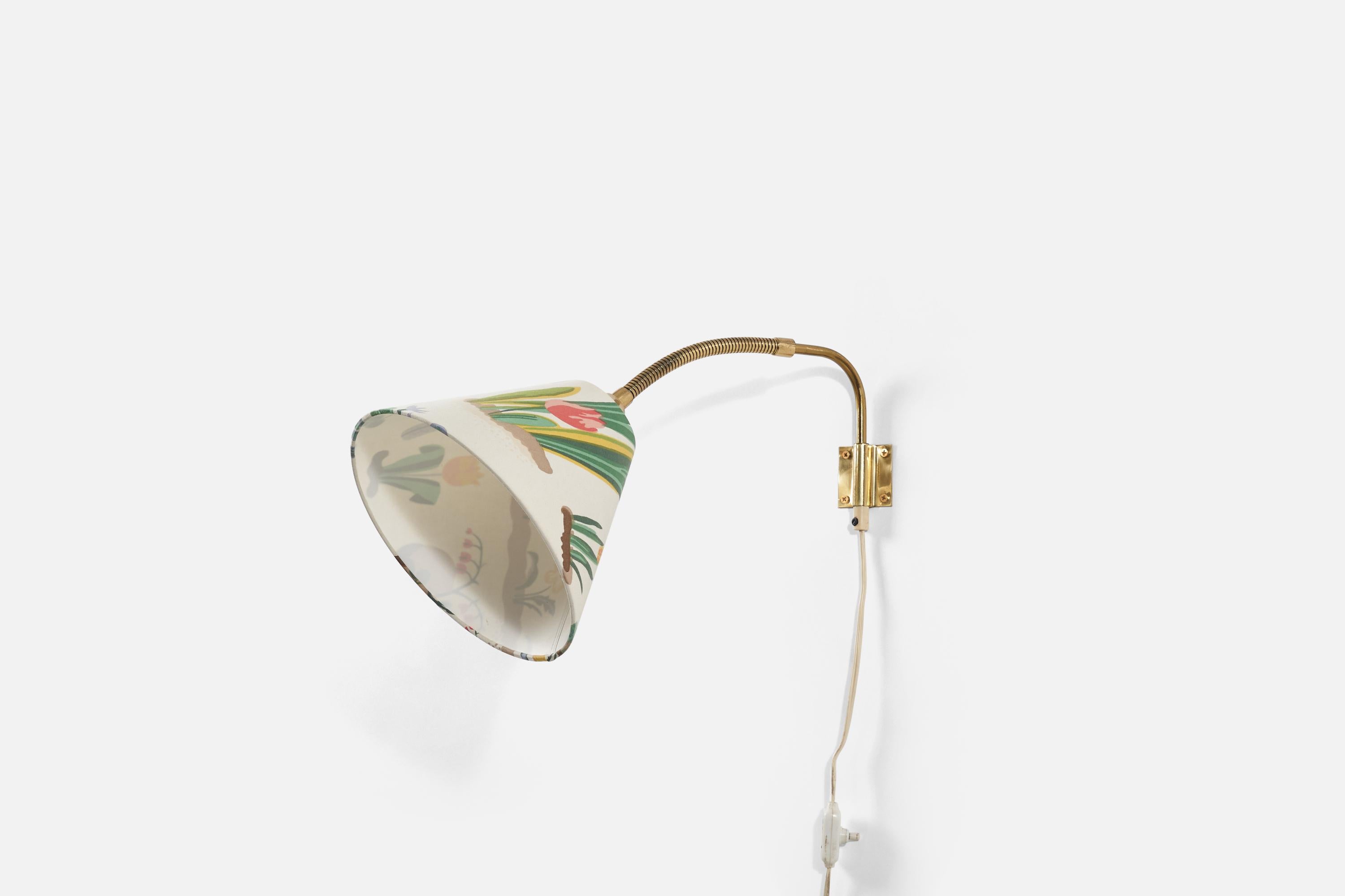A brass and fabric wall light produced by a Swedish designer, Sweden, 1960s.