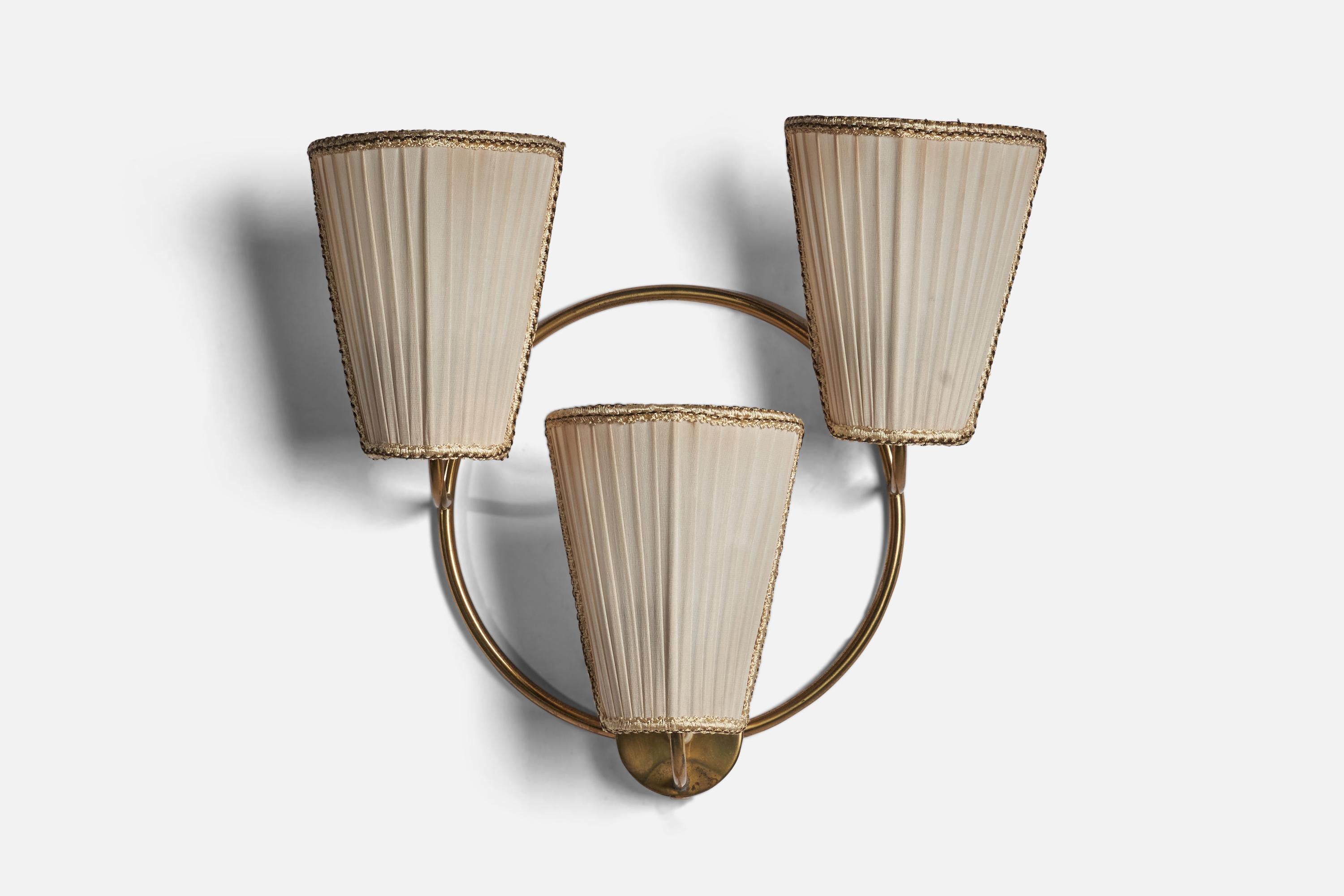 A three-armed brass and off-white fabric wall light designed and produced in Sweden, 1940s.

Overall Dimensions (inches): 16” H x 17” W x 5.2”D
Back Plate Dimensions (inches): 3 inch diameter, 1 inch depth
Bulb Specifications: E-26 Bulb
Number of