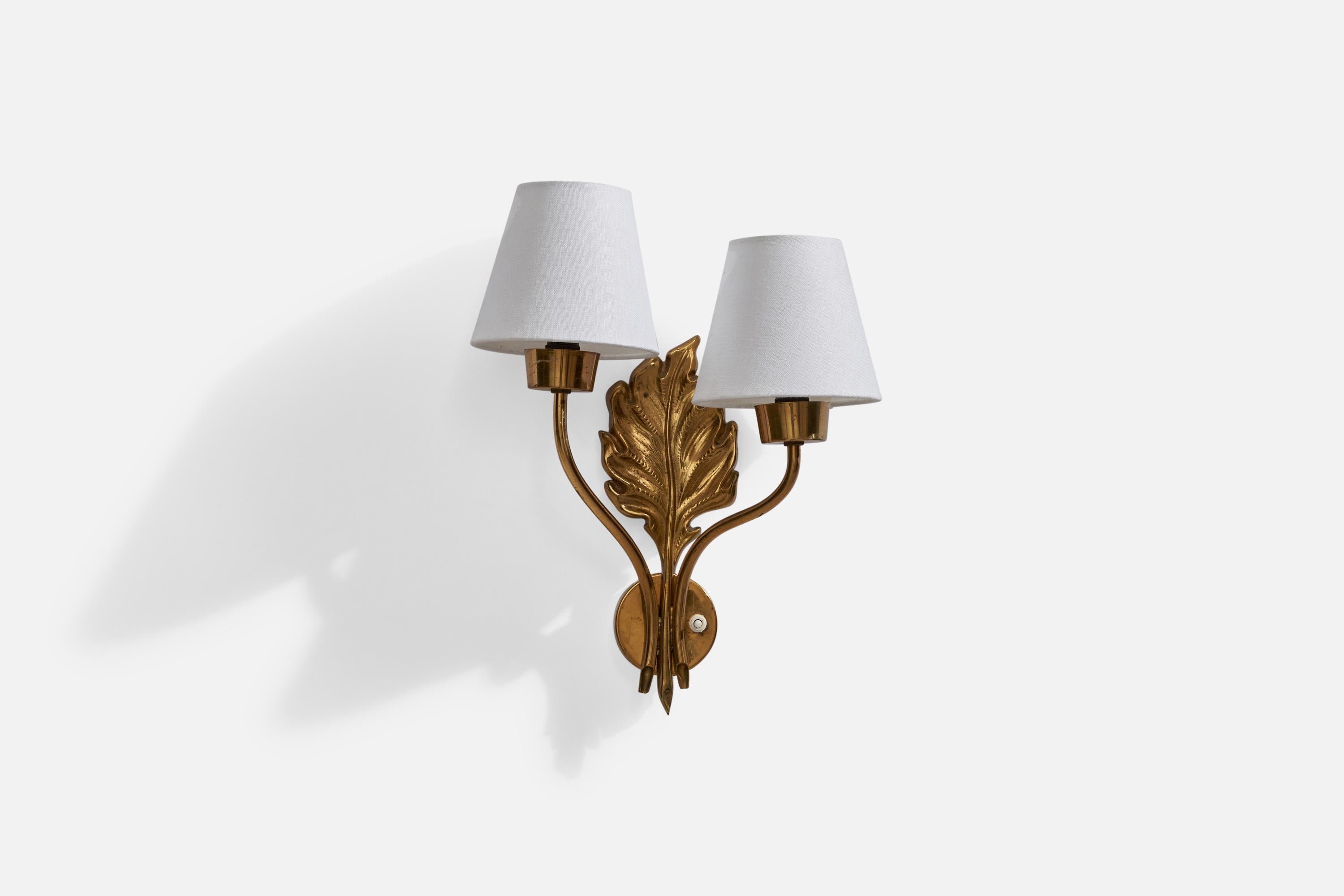 A two-armed brass and white fabric wall light designed and produced in Sweden, 1940s.

Overall Dimensions (inches): 14.5” H x 11.5”  W x 5.75” D
Back Plate Dimensions (inches): 2.75” H x 2.75” W x .75” D
Bulb Specifications: E-14Bulb
Number of