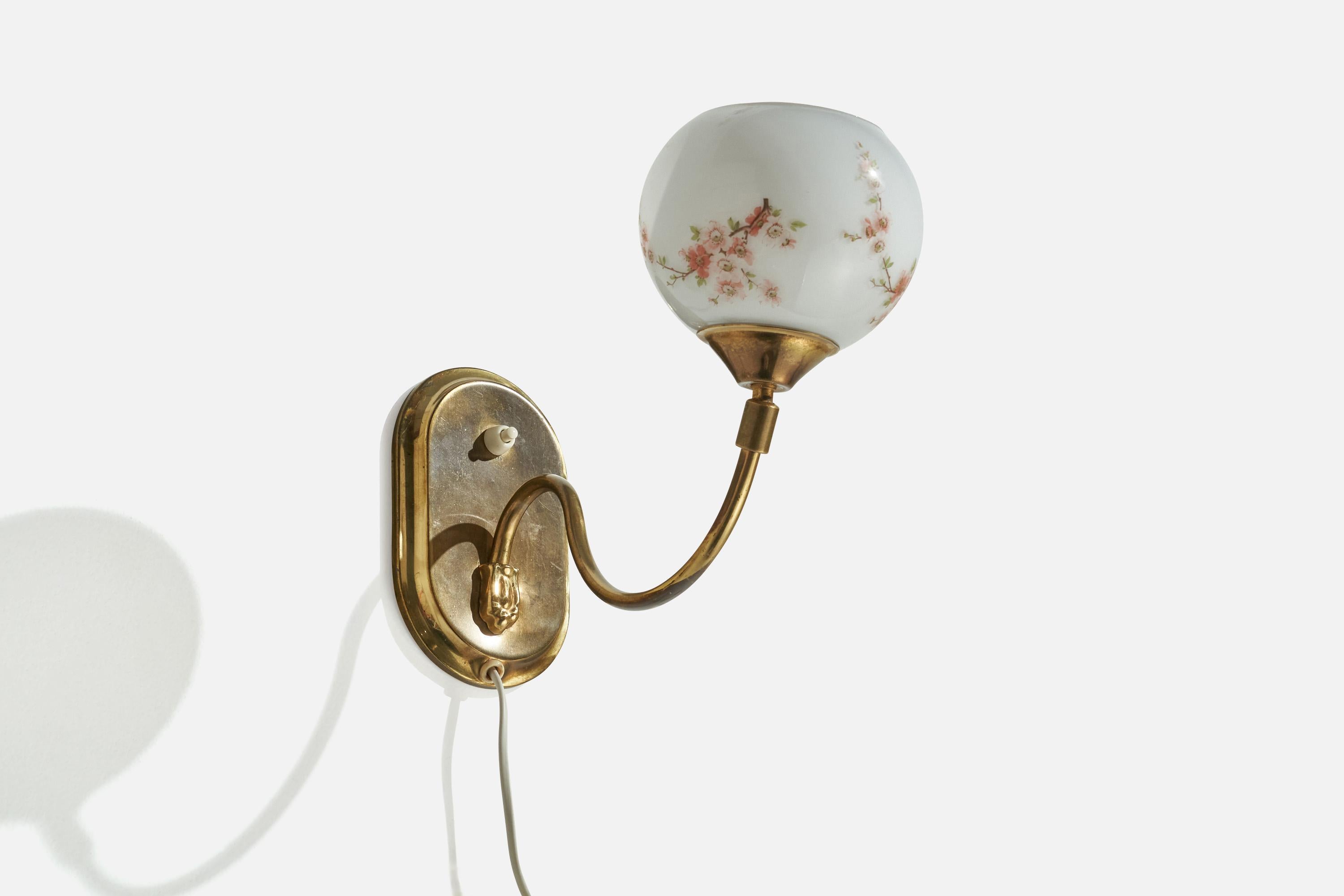 A brass and floral printed opaline glass wall light or table lamp designed and produced in Sweden, c. 1940s.

Overall Dimensions (inches): 6.5” H x 5” W x 12.5” D
overall dimensions depends on the position of the shade.
Back Plate Dimensions
