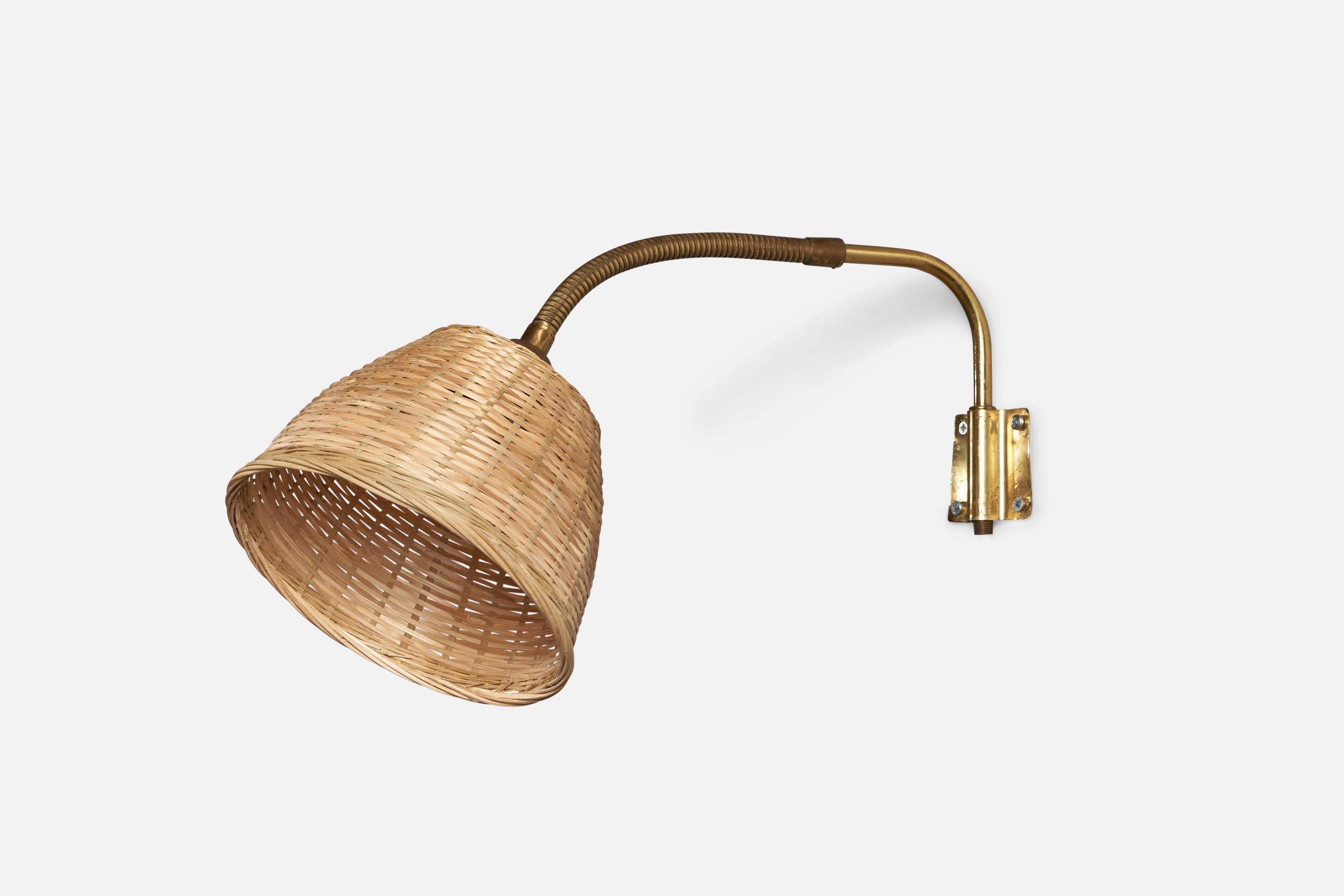 An adjustable brass and rattan wall light, designed and produced in Sweden, 1930s.

Overall Dimensions: 16