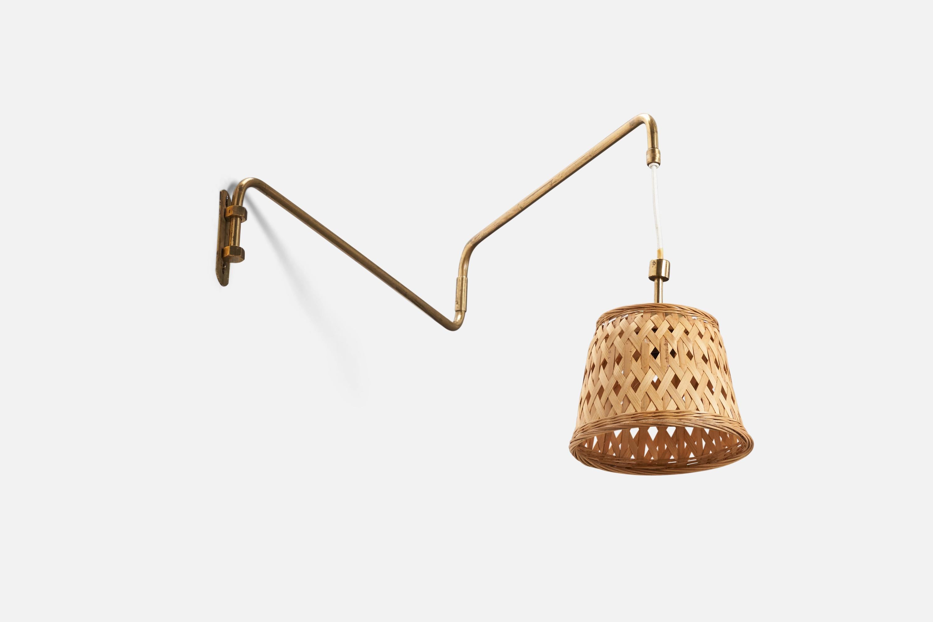 A brass and rattan wall light designed and produced by a Swedish Designer, Sweden, 1940s.

Dimensions variable, measurements listed are of sconce in its maximum extended position. 

Socket takes standard E-26 medium base bulb.

There is no