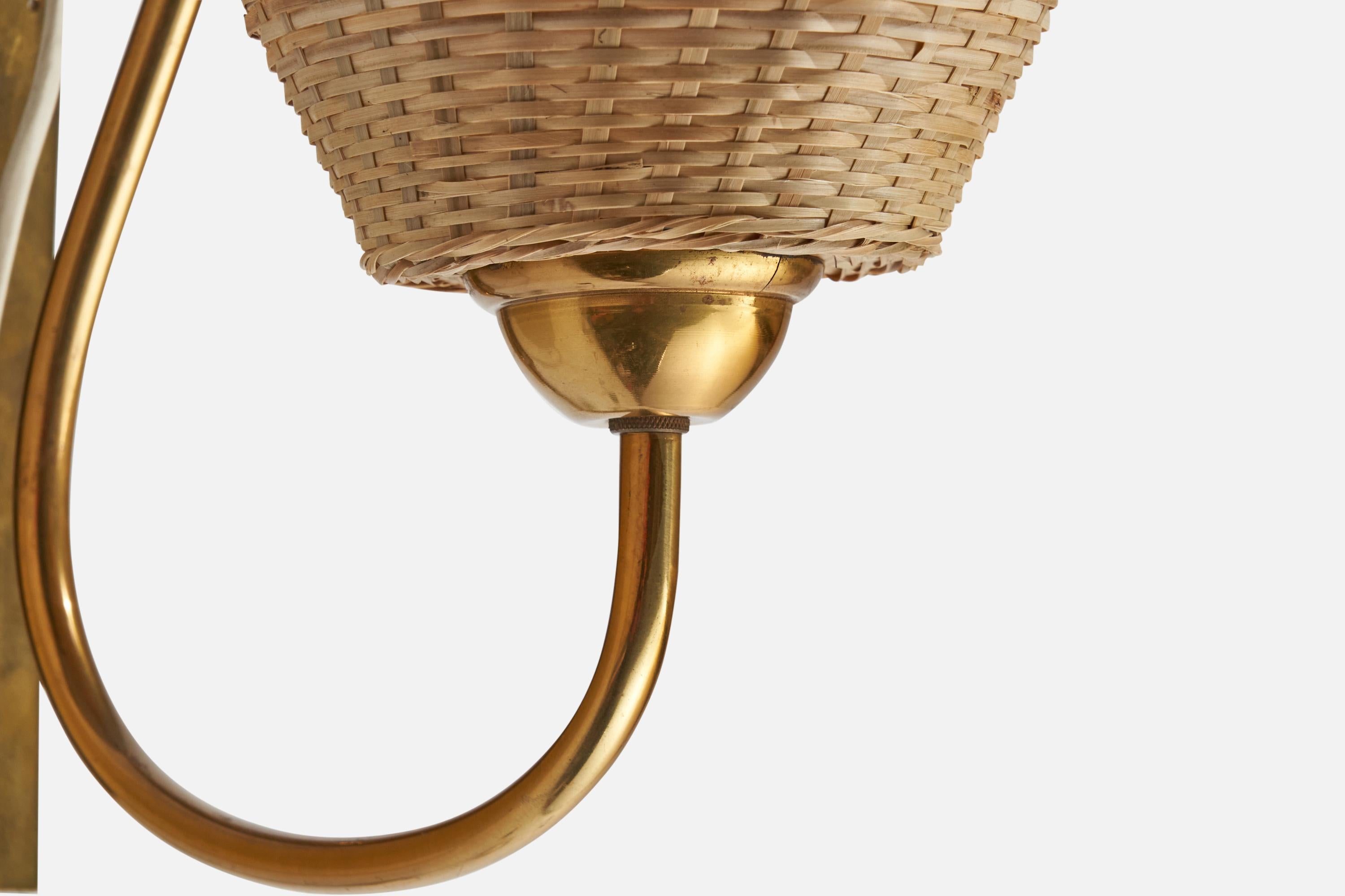 A brass and rattan wall light designed and produced in Sweden, 1940s.

Please note cord feeds from bottom of stem, configured for plug in.

Overall Dimensions (inches): 12” H x 7.5” W x 17.75” D
Back Plate Dimensions (inches): 8.8” H x 2.1” W x