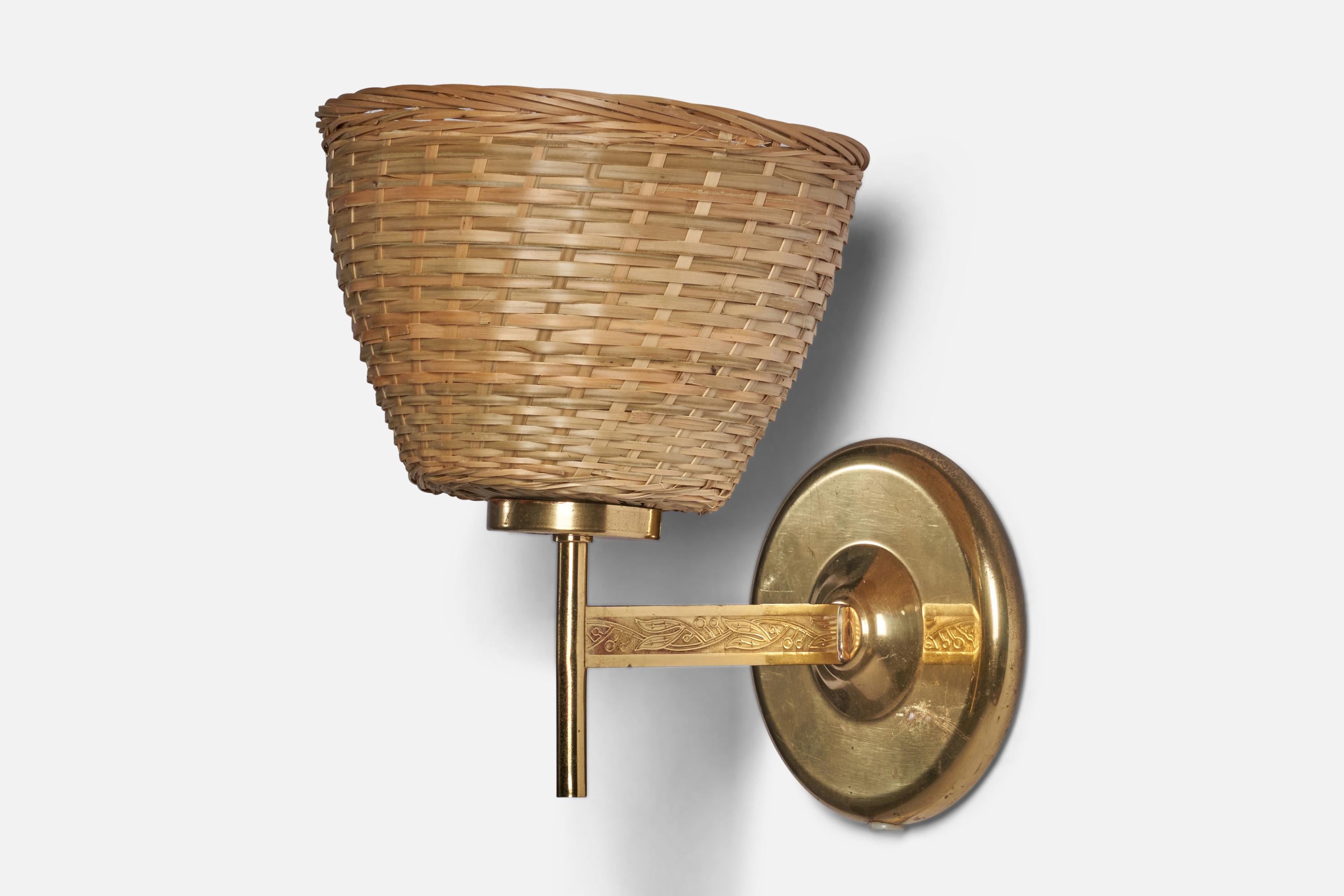 A brass and rattan wall light designed and produced in Sweden, 1950s.

Overall Dimensions (inches): 9” H x 7” W x 9” D
Back Plate Dimensions (inches): 5” Diameter
Bulb Specifications: E-26 Bulb
Number of Sockets: 1
All lighting will be converted for
